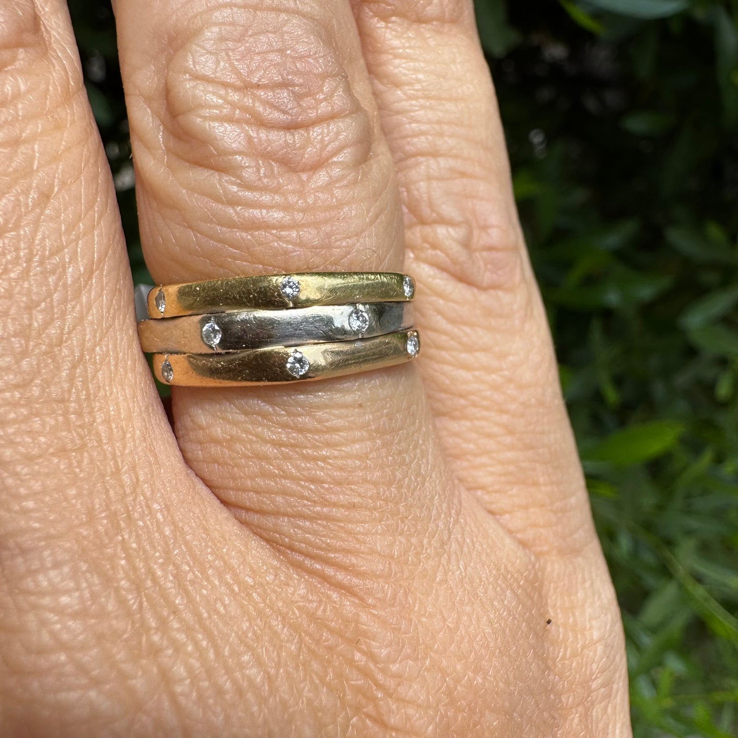 18K gold ring crafted in yellow, white, and rose gold, featuring a triple-band design set with Diamonds