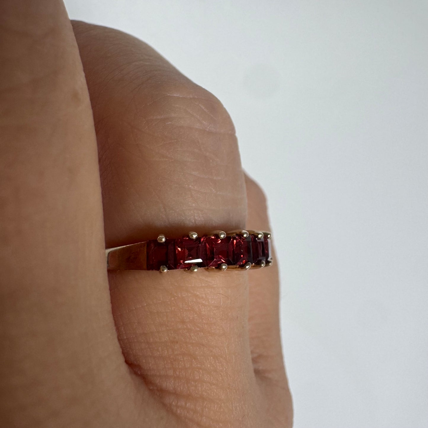 9K gold ring set with deep red garnets
