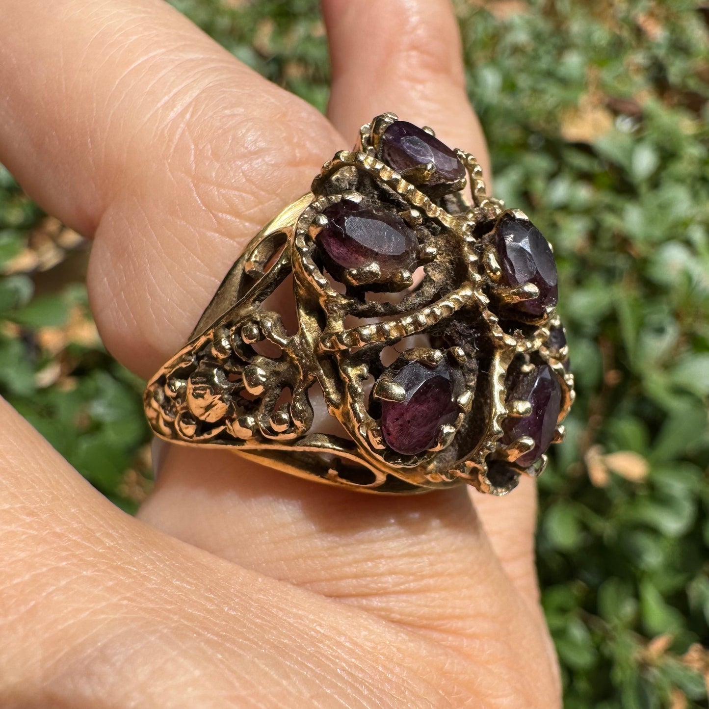 14K gold cocktail ring set with a stunning cluster of deep purple Garnet stones in marquise cuts.