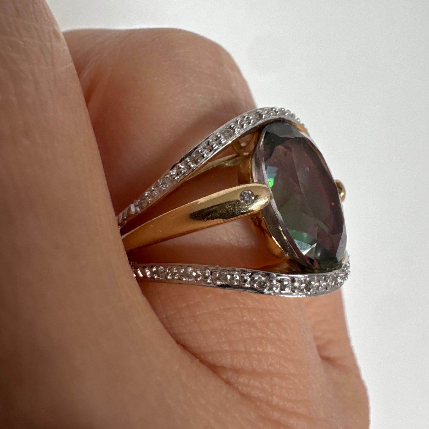 14K gold ring set with an oval Mystic Topaz