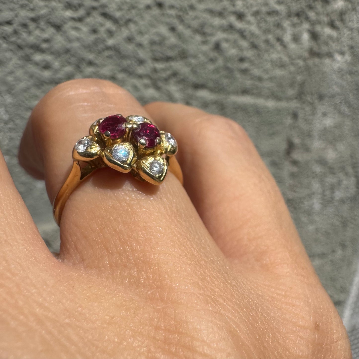 18K gold ring designed like a flower, set with two deep red Rubies and sparkling Diamonds