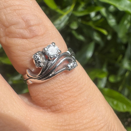 14K gold ring set with round-cut diamonds in a flowing design