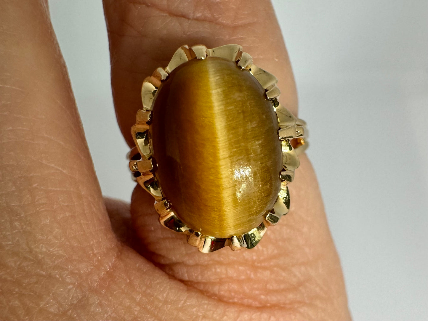 14K gold ring set with a yellow Tiger’s Eye cabochon