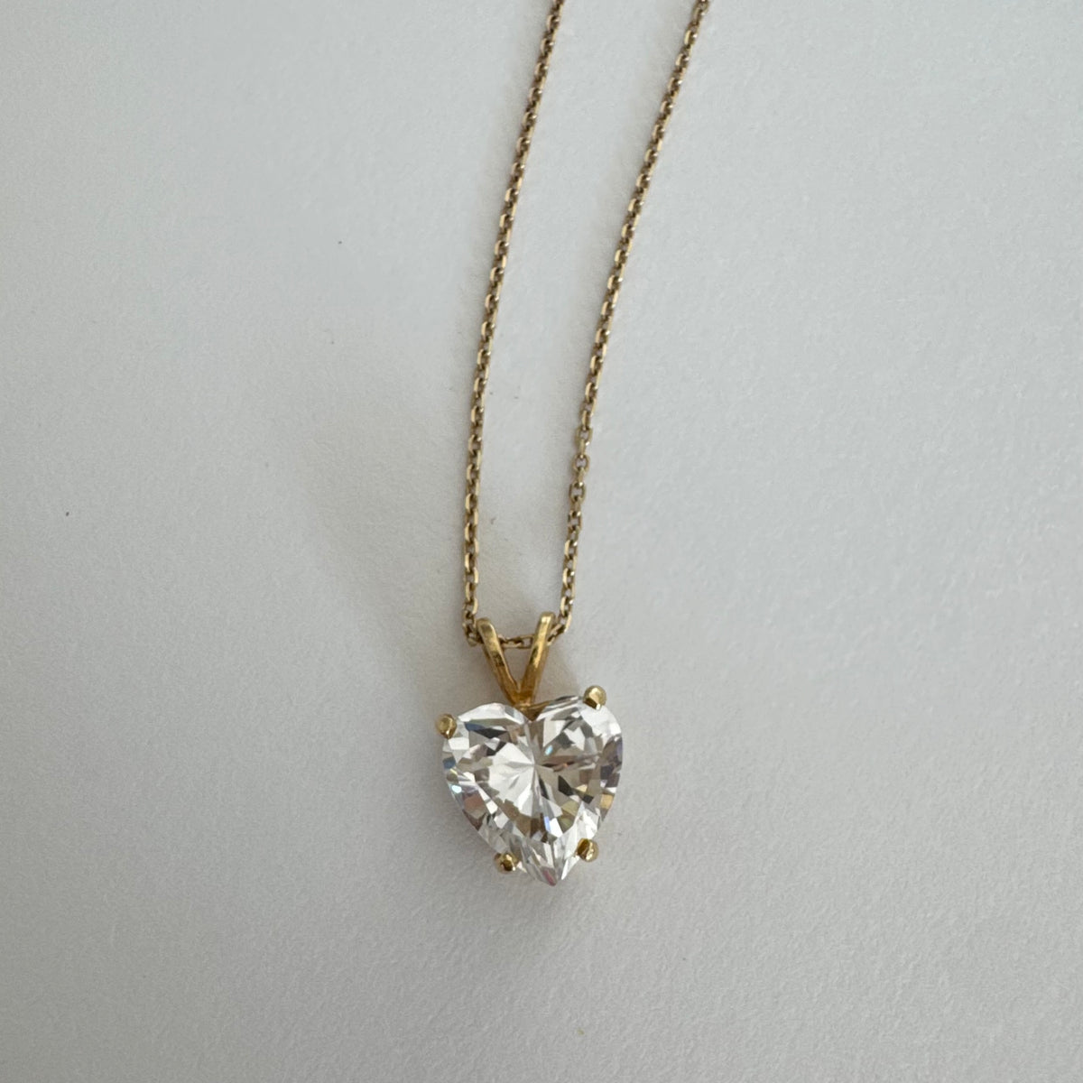 14K gold Heart Pendant set with a brilliant heart-cut clear stone.