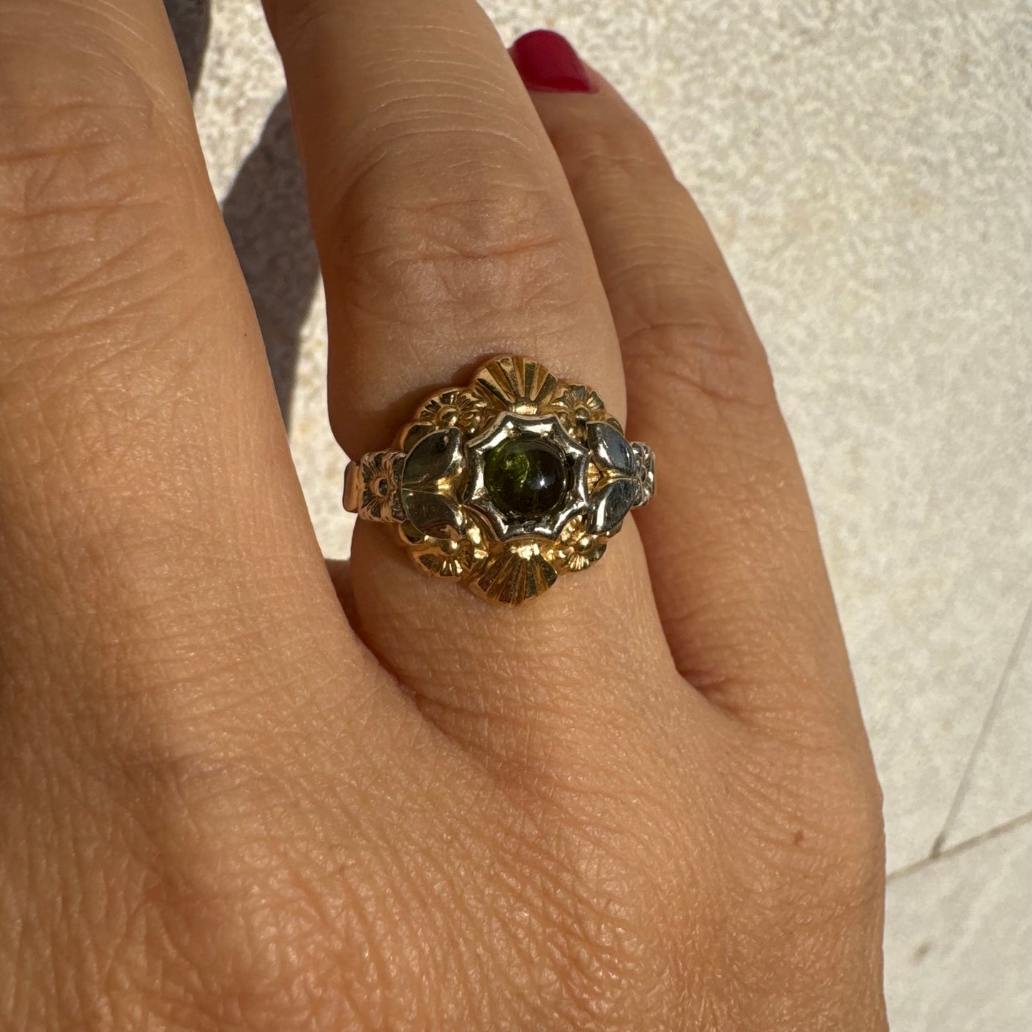 18K two-tone gold ring set with a deep green Tourmaline gemstone.