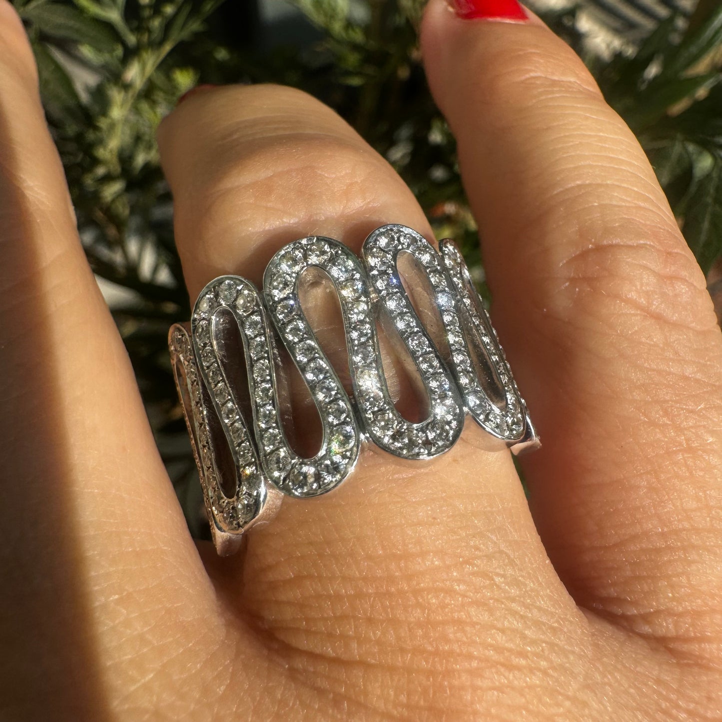 14K gold ring set with shimmering Diamonds in a flowing wave design