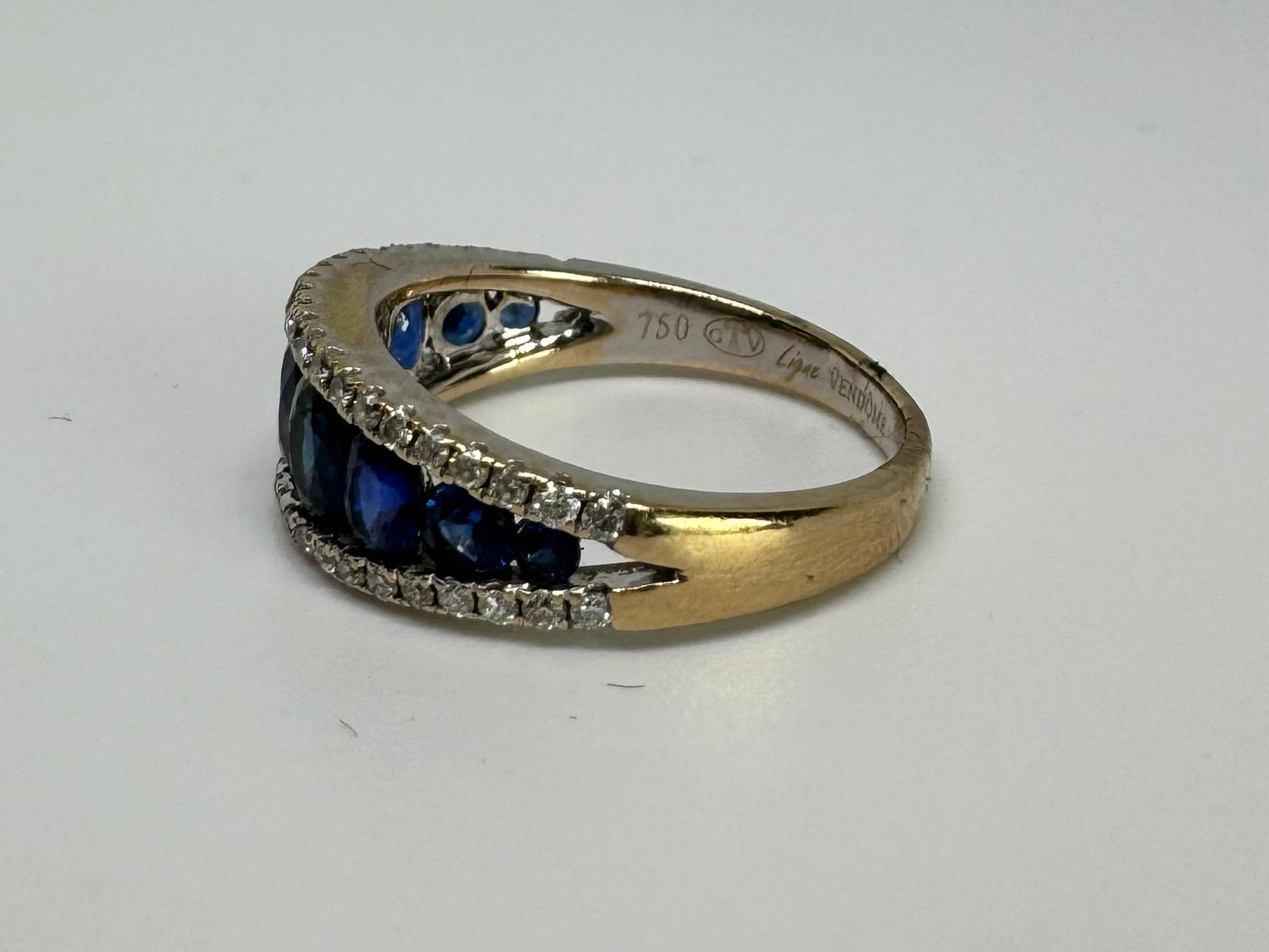 18K gold ring set with a row of deep blue Sapphire & Diamonds