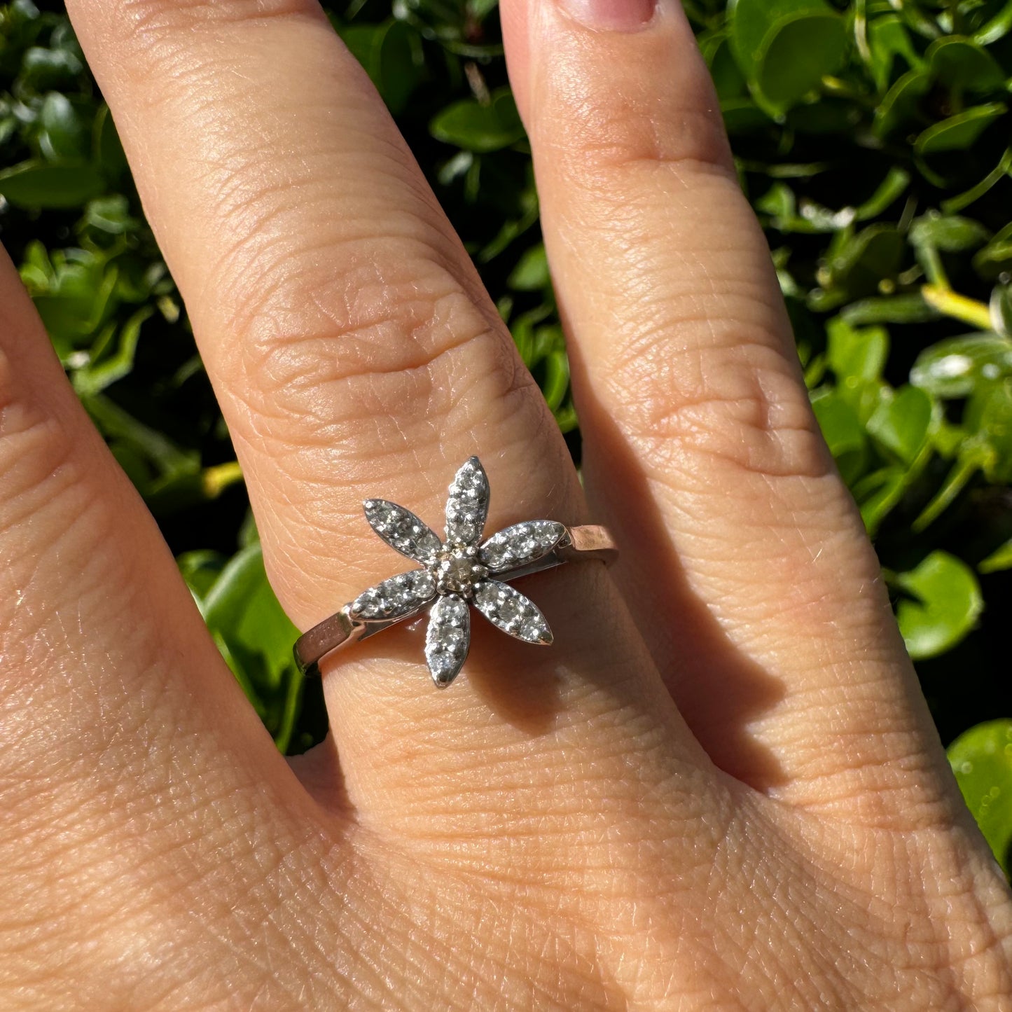 14K gold ring set with a floral design with six petal-shaped segments, each pavé-set with shimmering Diamonds