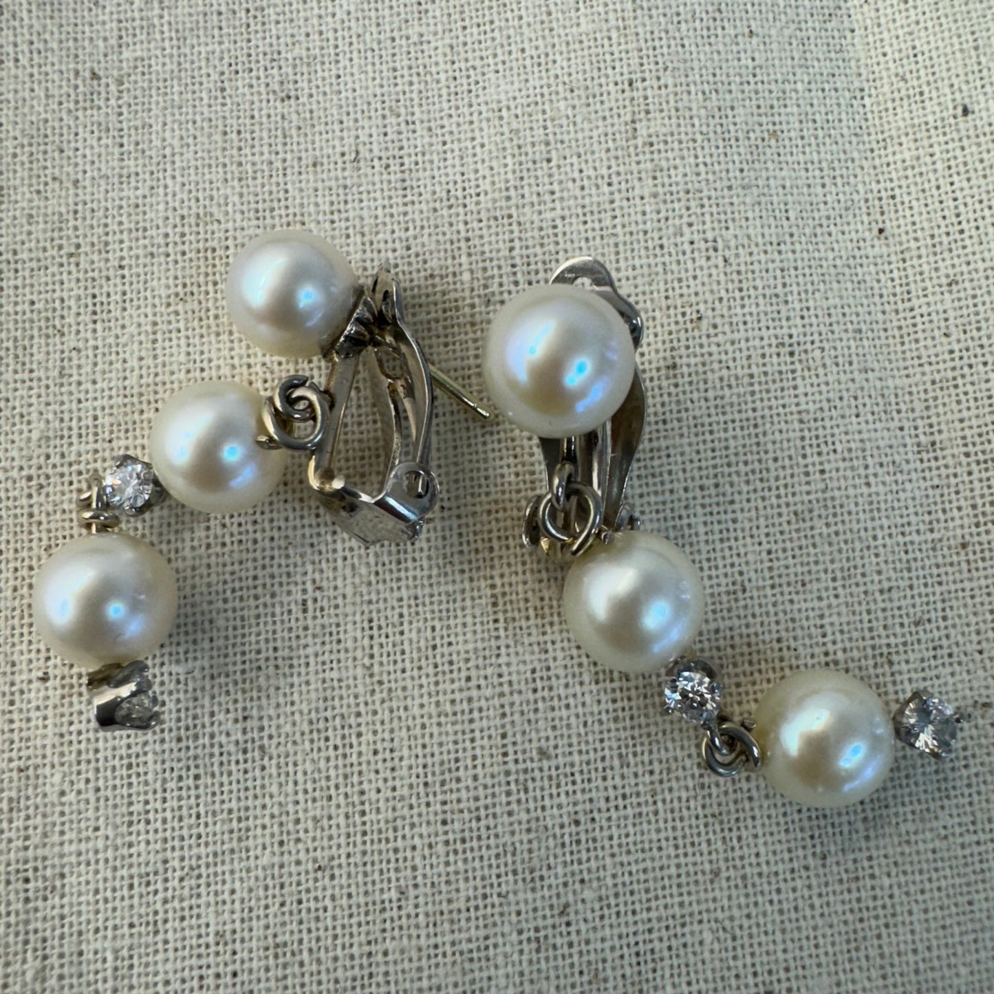 14K gold elegant drop earring set with three soft creamy Pearls connected by round brilliant Diamonds