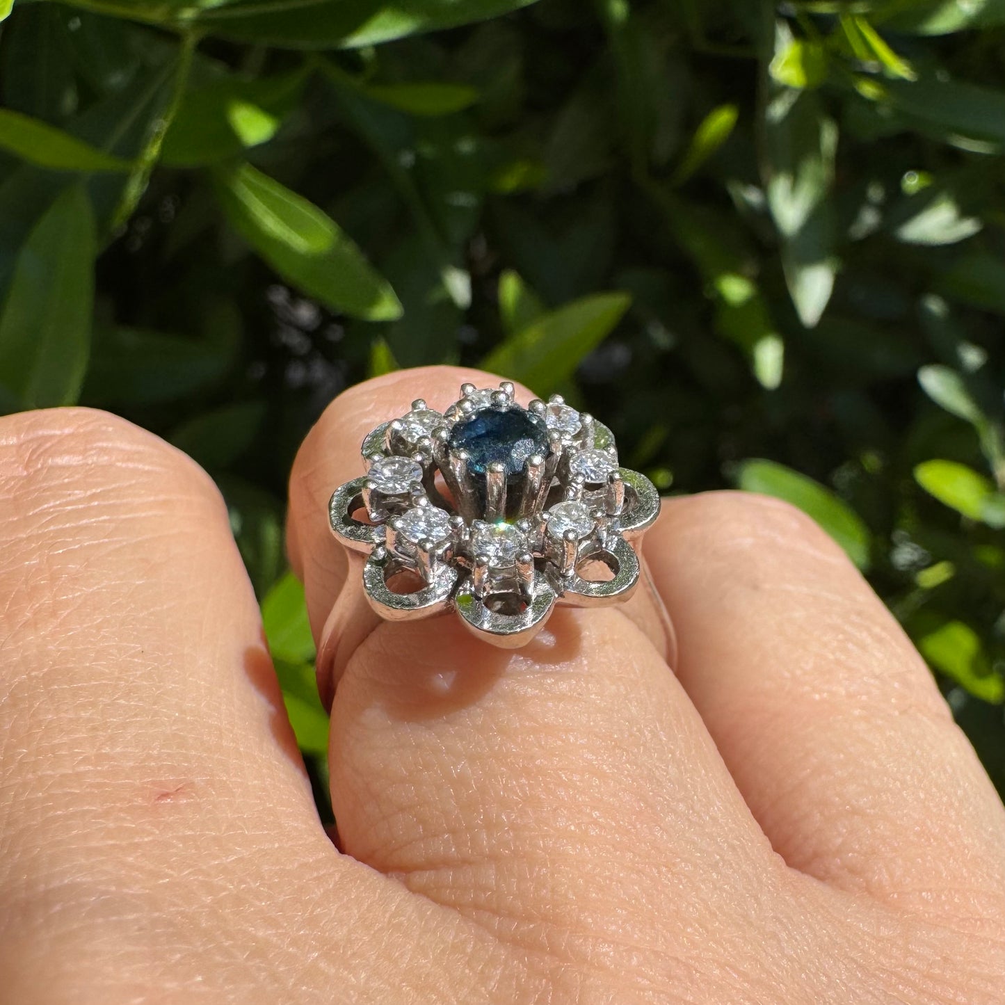 14K gold floral ring set with a round deep blue Sapphire at its center & Diamonds