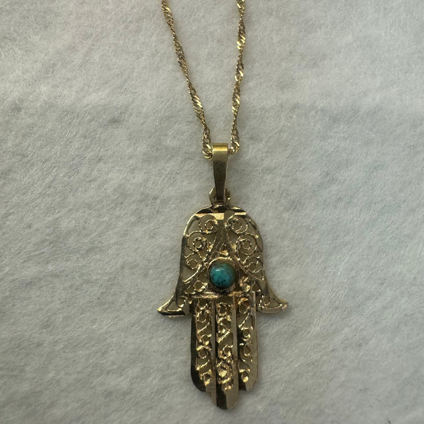 14K gold necklace with “Hamsa” pendant set with a center Turquoise stone