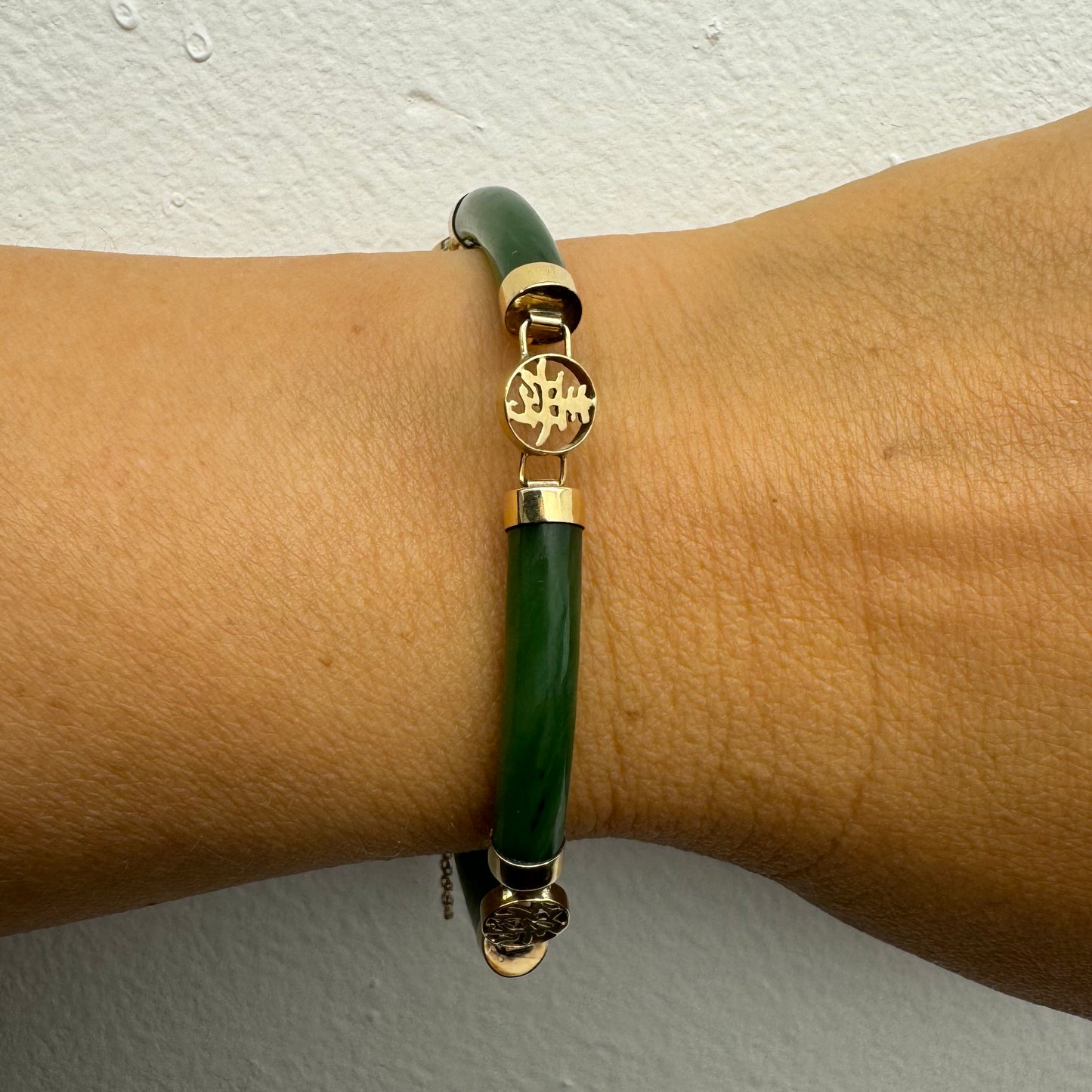 צמיד זהב צהוב 18 קראט משובץ אבני ג’ייד ירוקות עם עיטורי זהב בעיצוב אסייתי מסורתי – שילוב הרמוני של אלגנטיות, משמעות רוחנית וסטייל ייחודי
