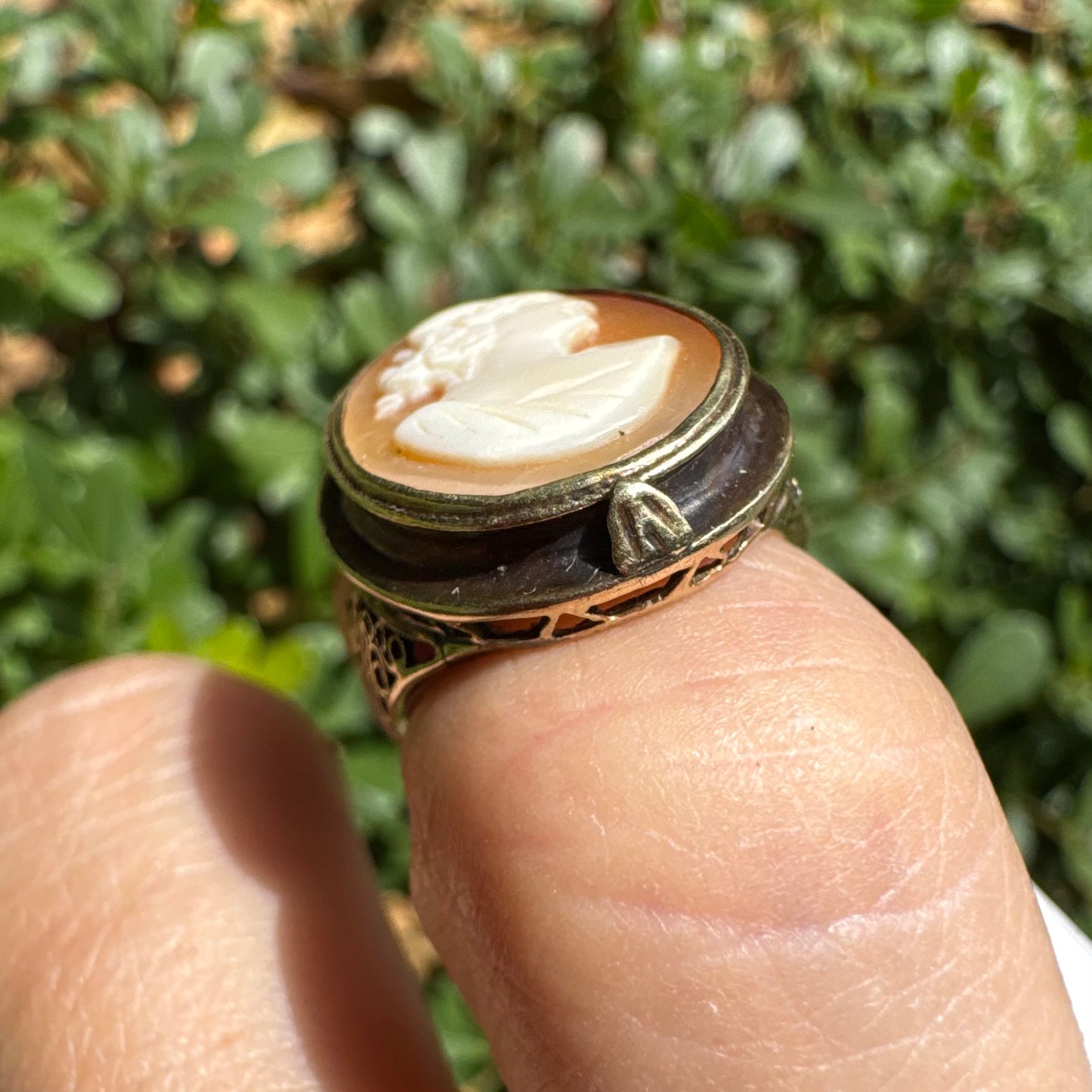 14K gold cameo ring featuring a finely carved portrait of a woman in profile, set in an oval bezel with intricate gold detailing