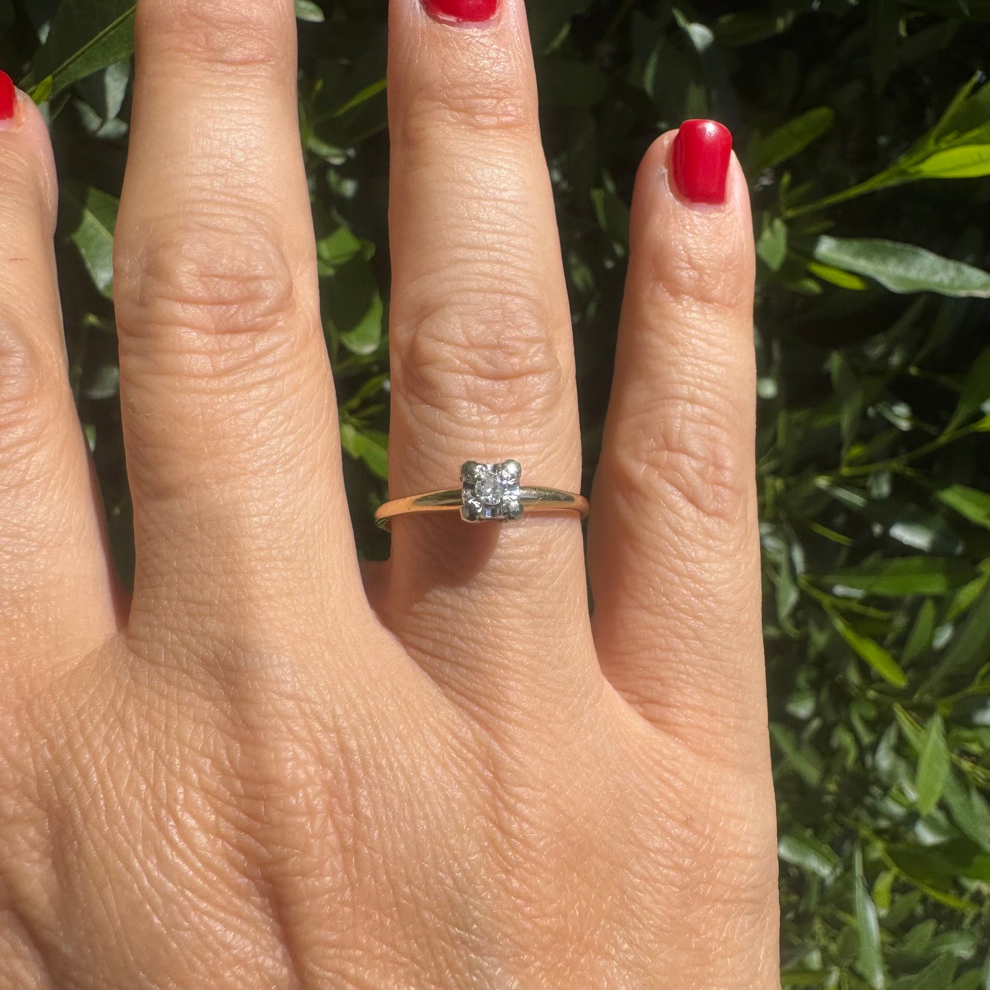 14K gold solitaire ring set with a small round Diamond