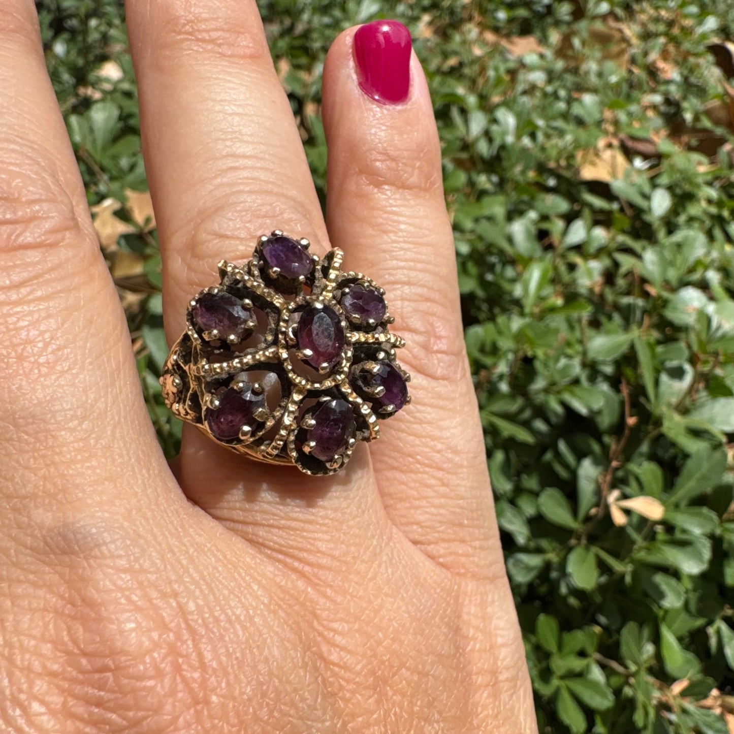 14K gold cocktail ring set with a stunning cluster of deep purple Garnet stones in marquise cuts.