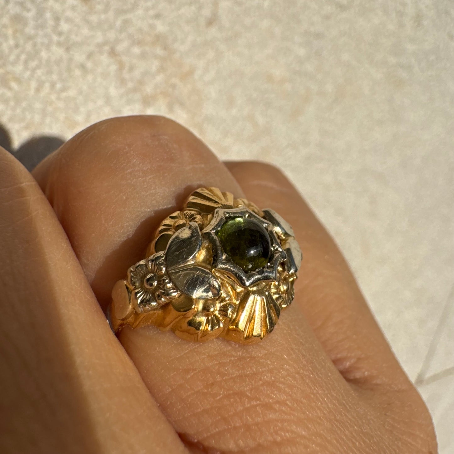 18K two-tone gold ring set with a deep green Tourmaline gemstone.