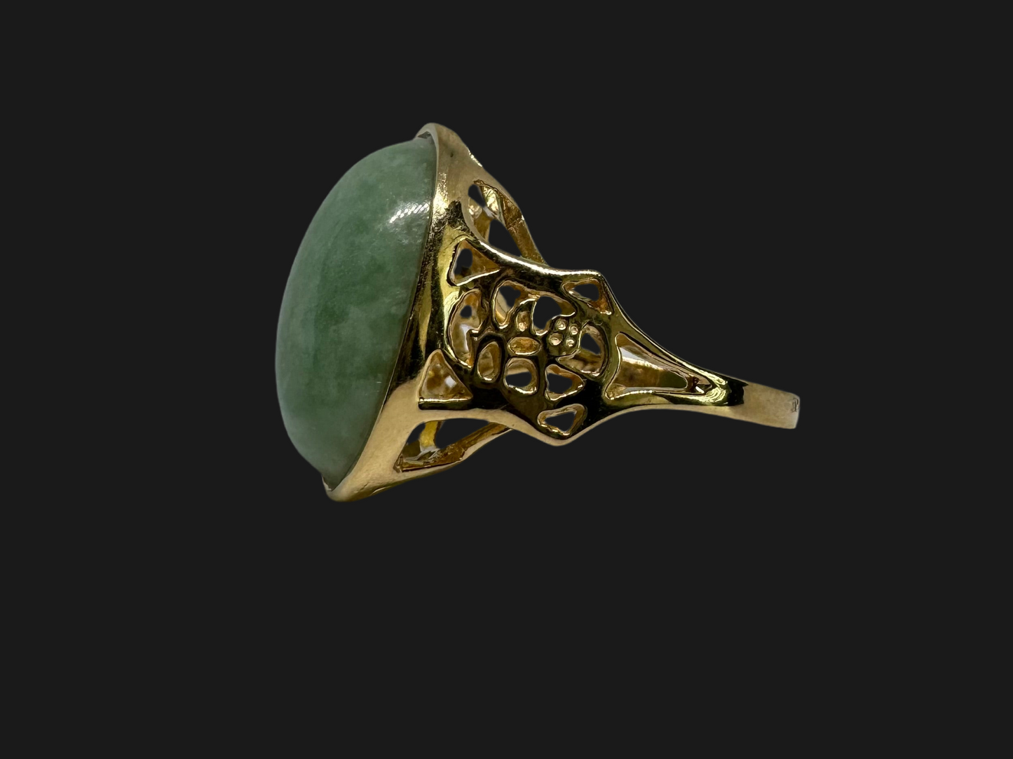 14K gold ring featuring a large oval light green Jade with a smooth polished finish, set in a classic bezel setting.