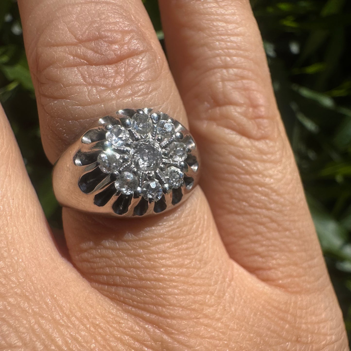 14K gold ring set with a cluster of old cut diamonds arranged in a floral design