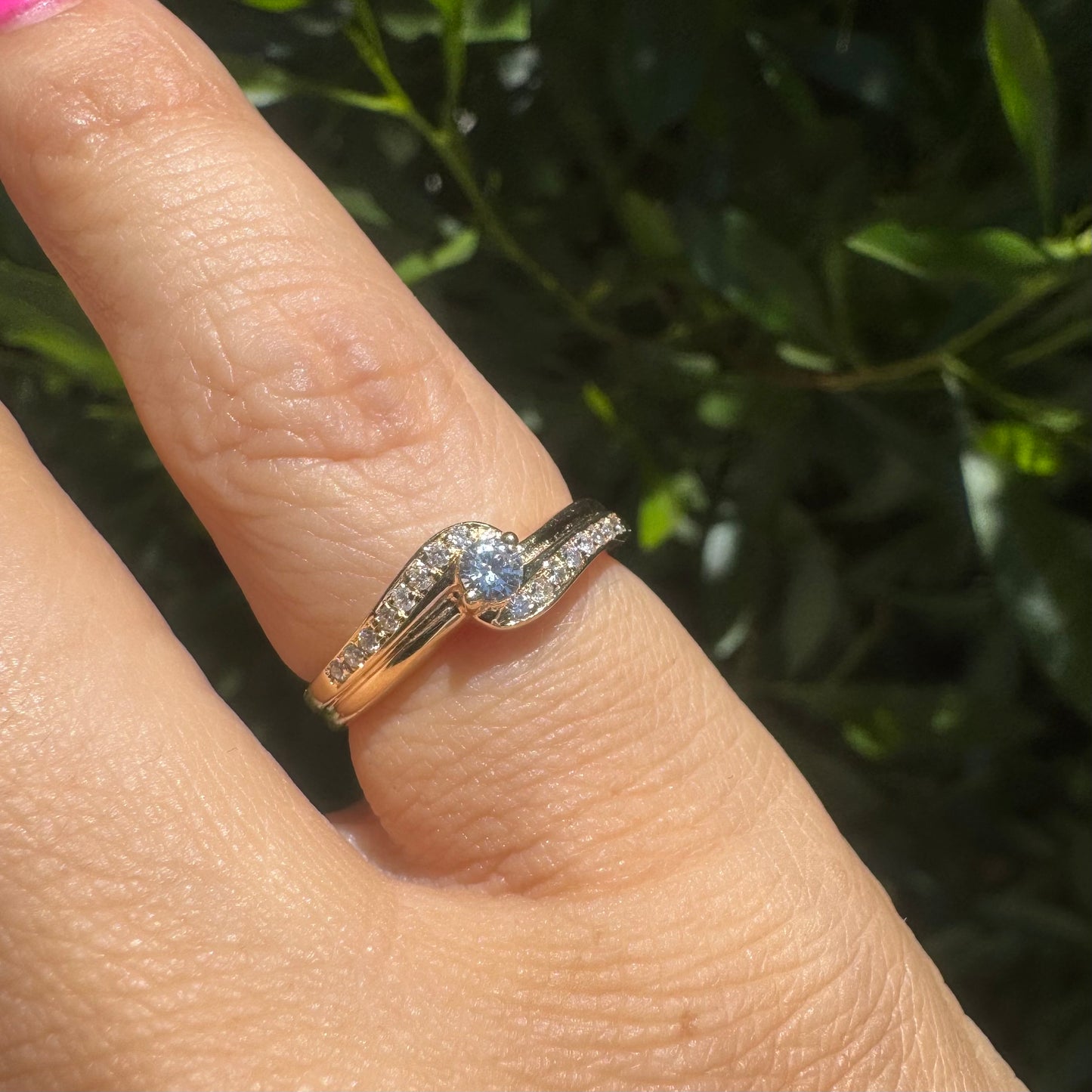 14K gold ring featuring a classic solitaire Diamond at its center, embraced by a pavé-set band