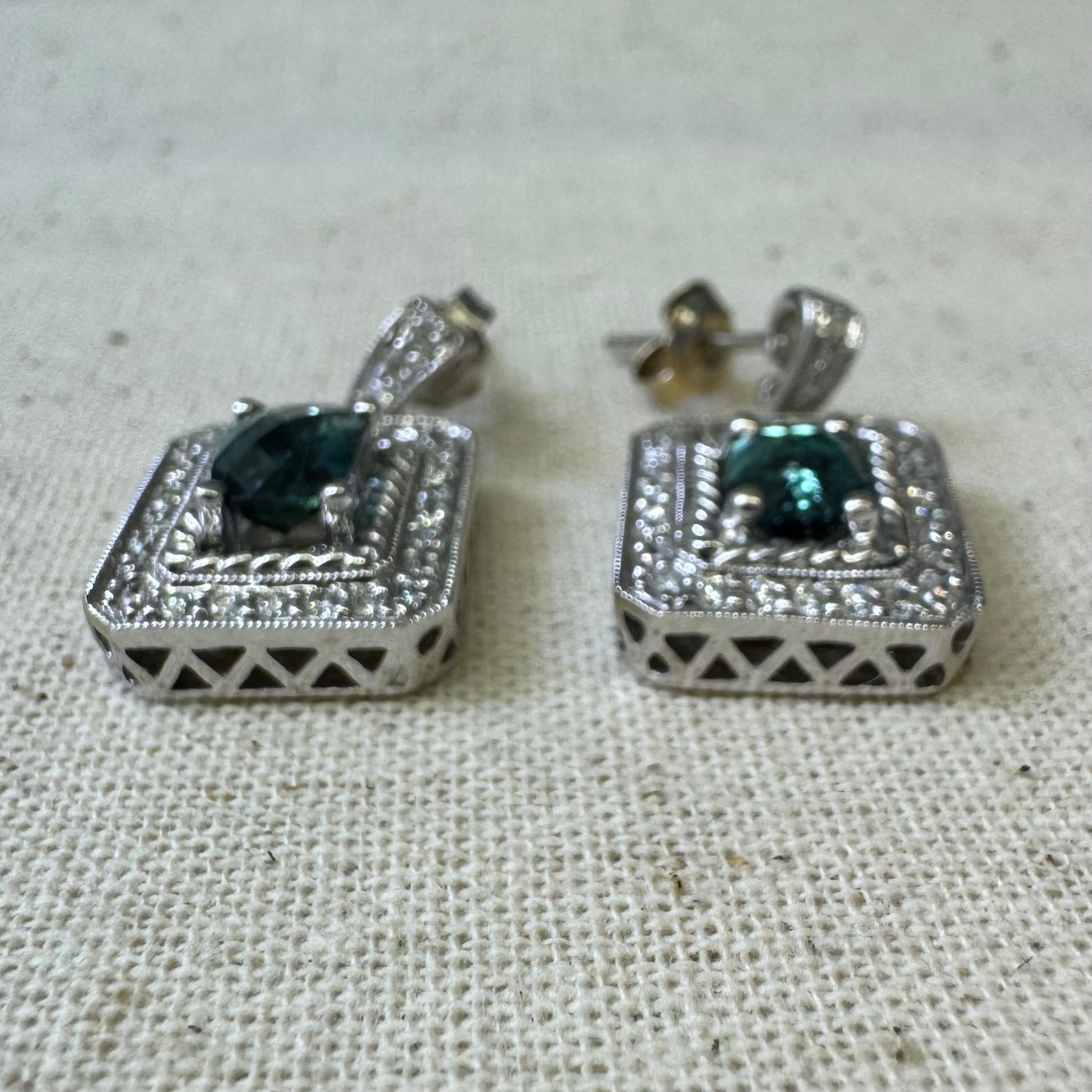 14K gold drop earrings set with emerald-cut Blue Topaz, surrounded by a halo of sparkling Diamonds