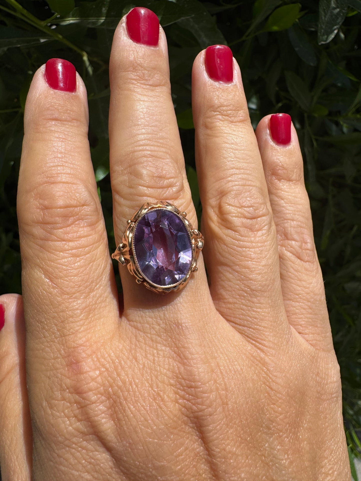 14K gold ring set with a large oval-cut Amethyst in a regal claw setting.