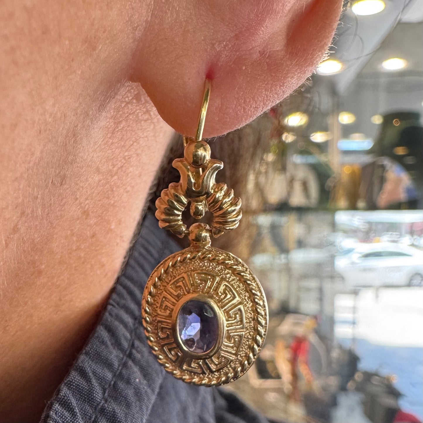 14K gold drop earrings set with Tanzanite in ornate medallion