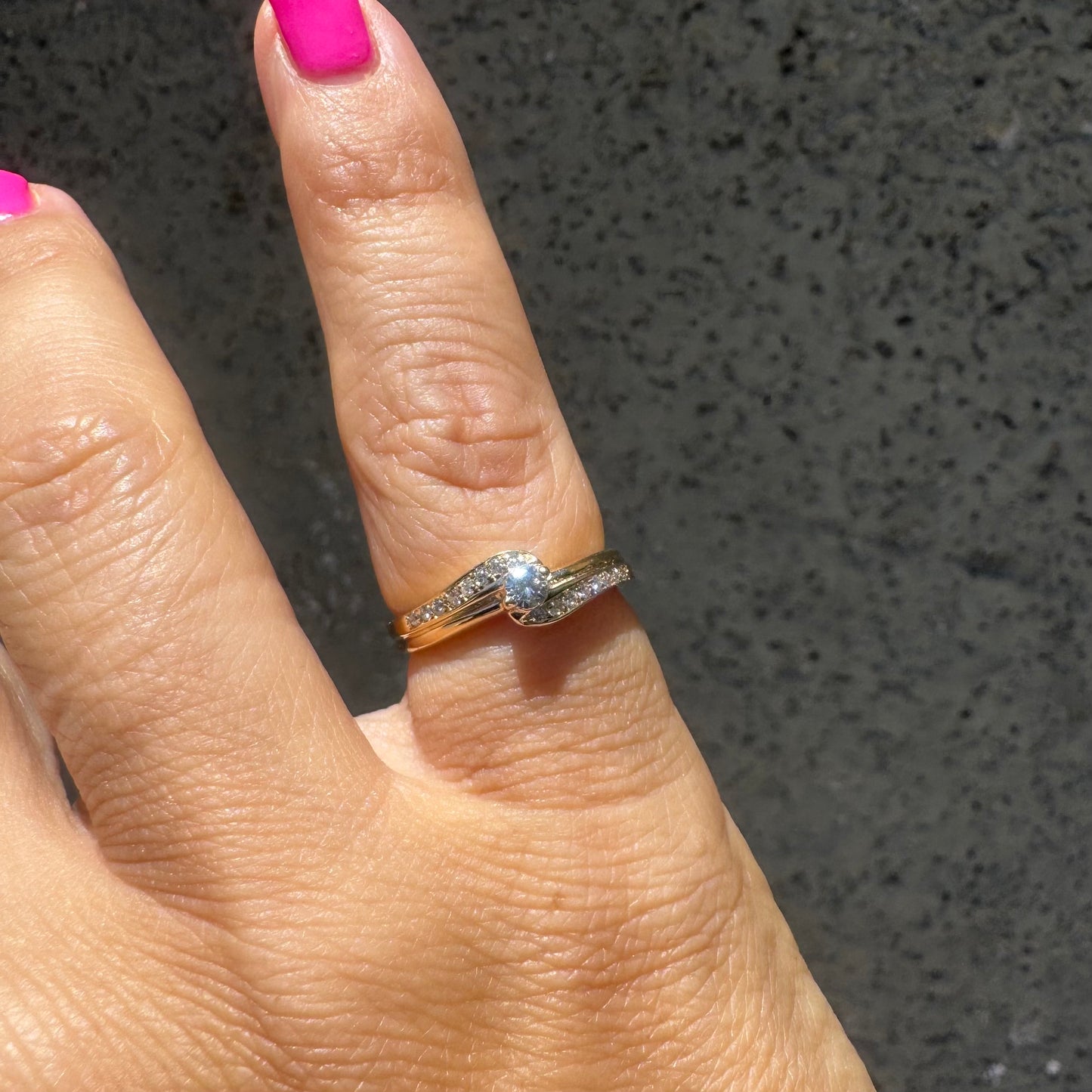 14K gold ring featuring a classic solitaire Diamond at its center, embraced by a pavé-set band