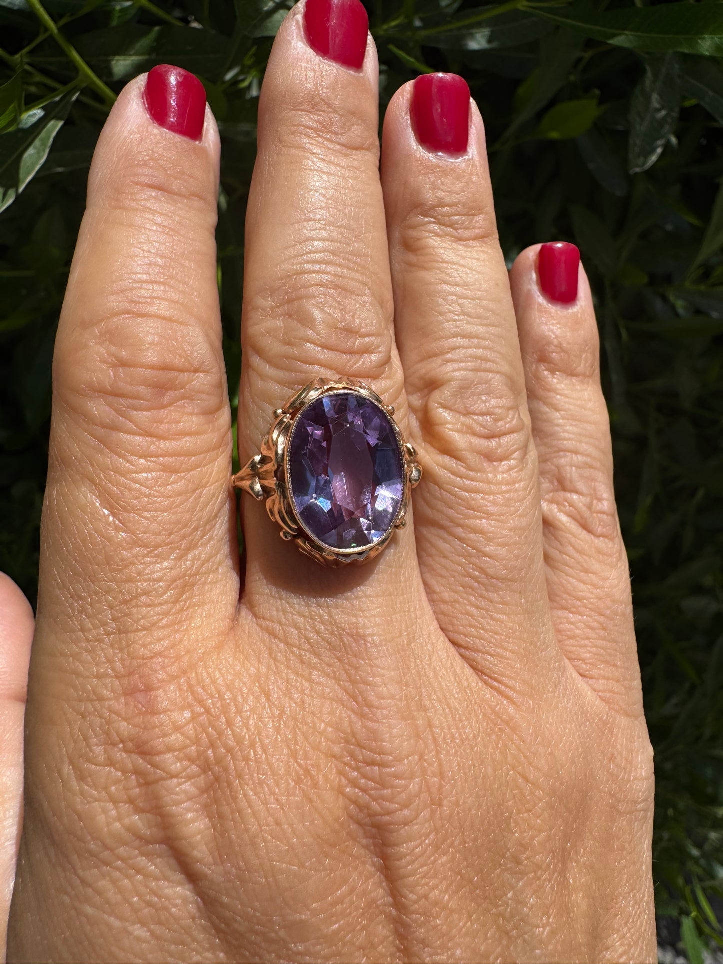 14K gold ring set with a large oval-cut Amethyst in a regal claw setting.