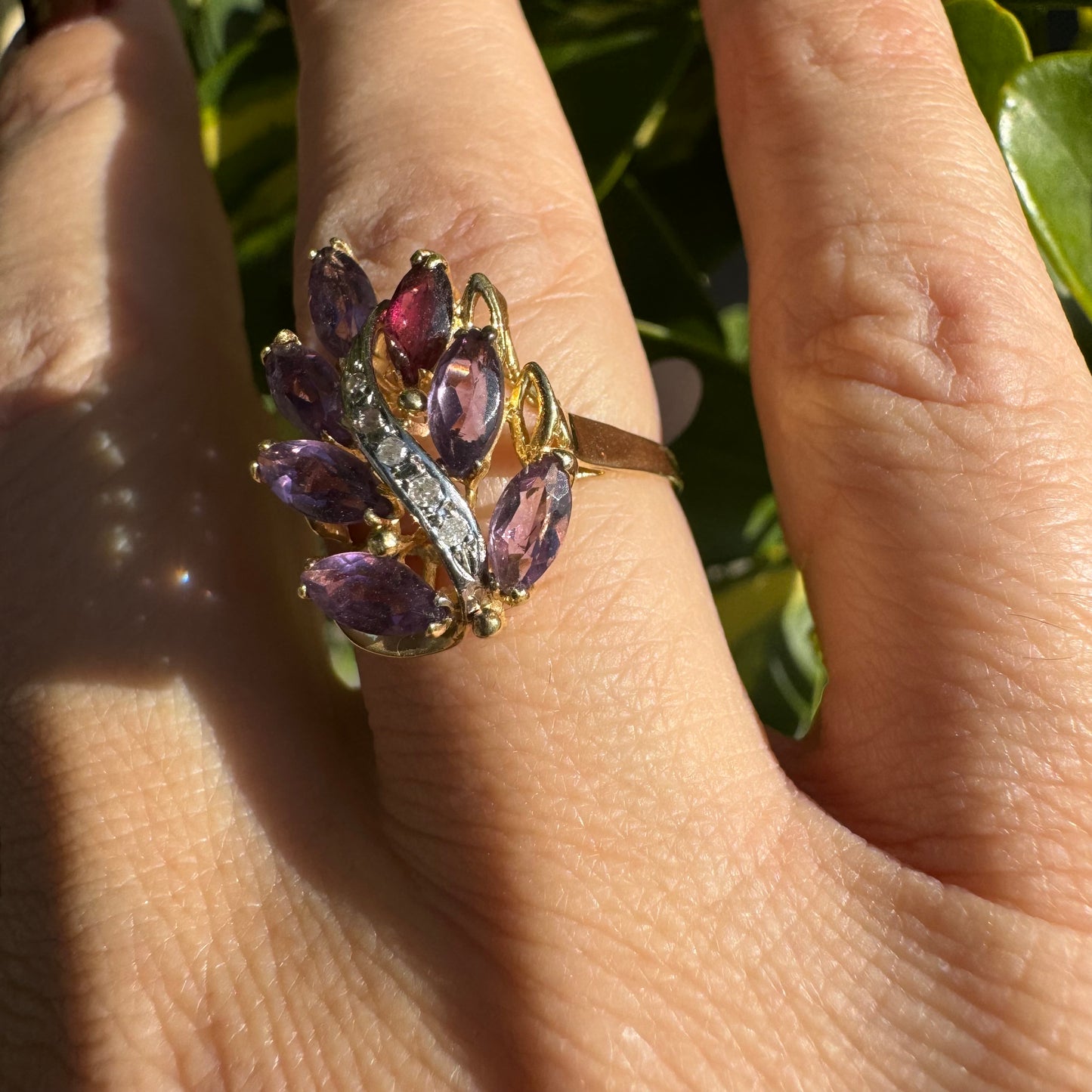 14K gold ring designed in a leaf motif, set with 7 marquise-cut Amethyst and accented by a curved line of sparkling Diamonds
