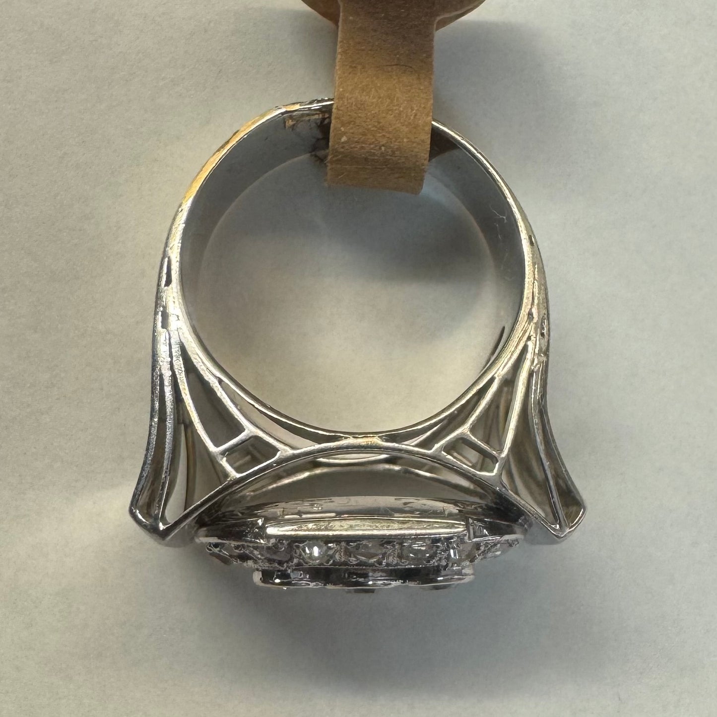 18K gold ring featuring three round 3 Diamonds in the center, framed by a rectangular halo of smaller Diamonds.