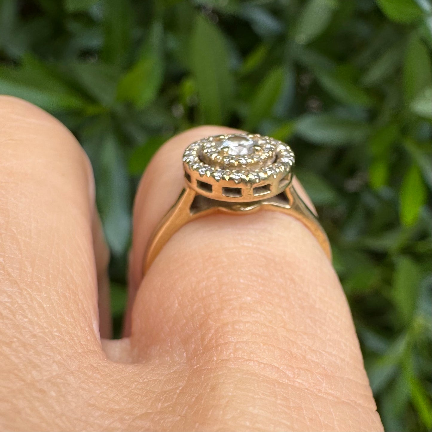 14K gold ring with a round center Diamond, surrounded by two rows of small sparkling Diamonds.
