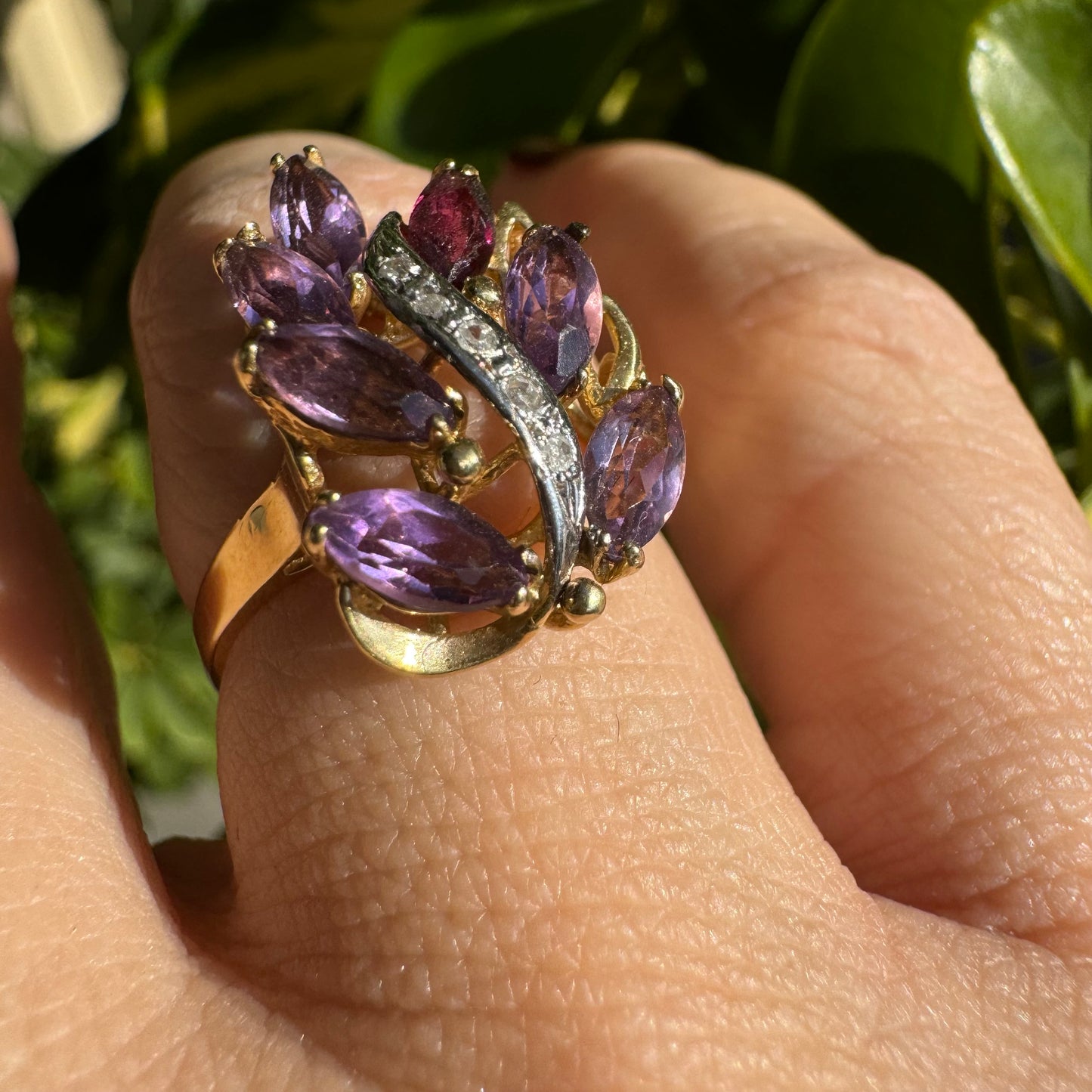 14K gold ring designed in a leaf motif, set with 7 marquise-cut Amethyst and accented by a curved line of sparkling Diamonds
