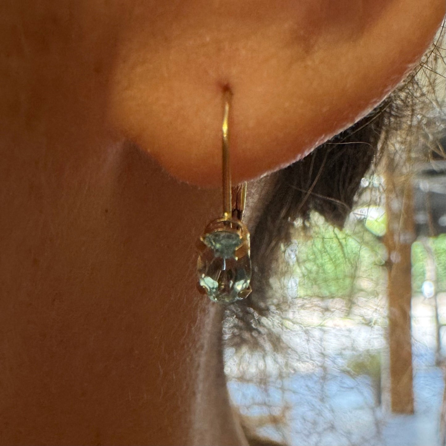 10K gold drop earrings set with sparkling blue topaz