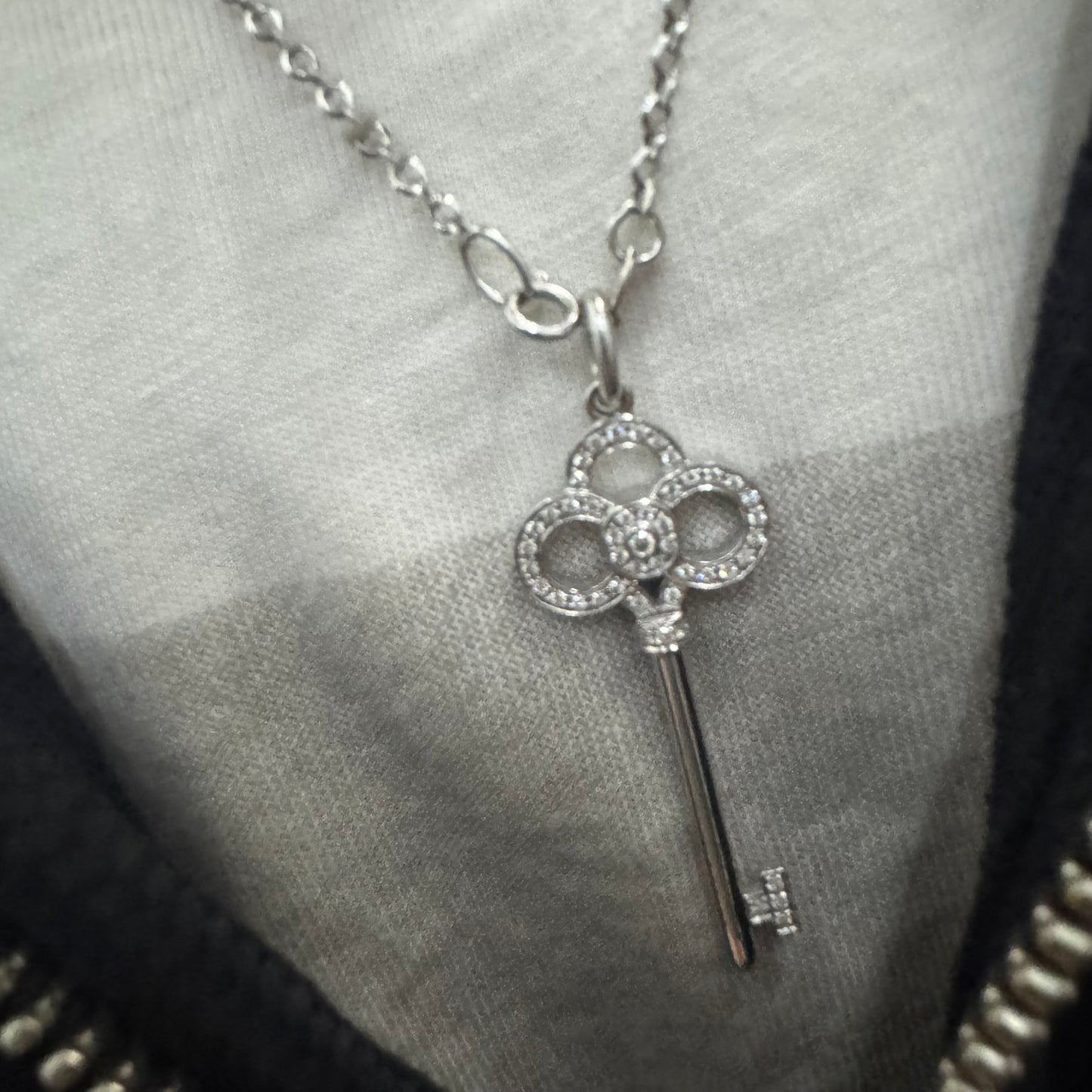 תליון מפתח אייקוני של Tiffany & Co. זהב לבן 18 קראט משובץ יהלומים עדינים.