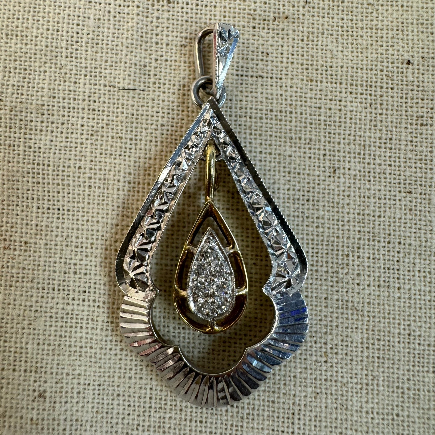 14K white and yellow gold pendant in a unique geometric design set with Diamonds