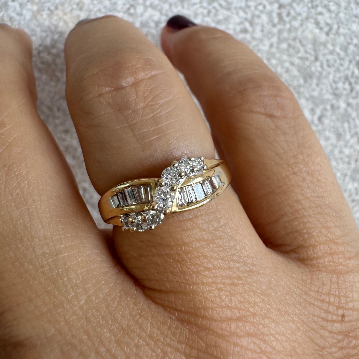 טבעת זהב צהוב 14 קראט משובצת יהלומים בחיתוך באגט ועגול.