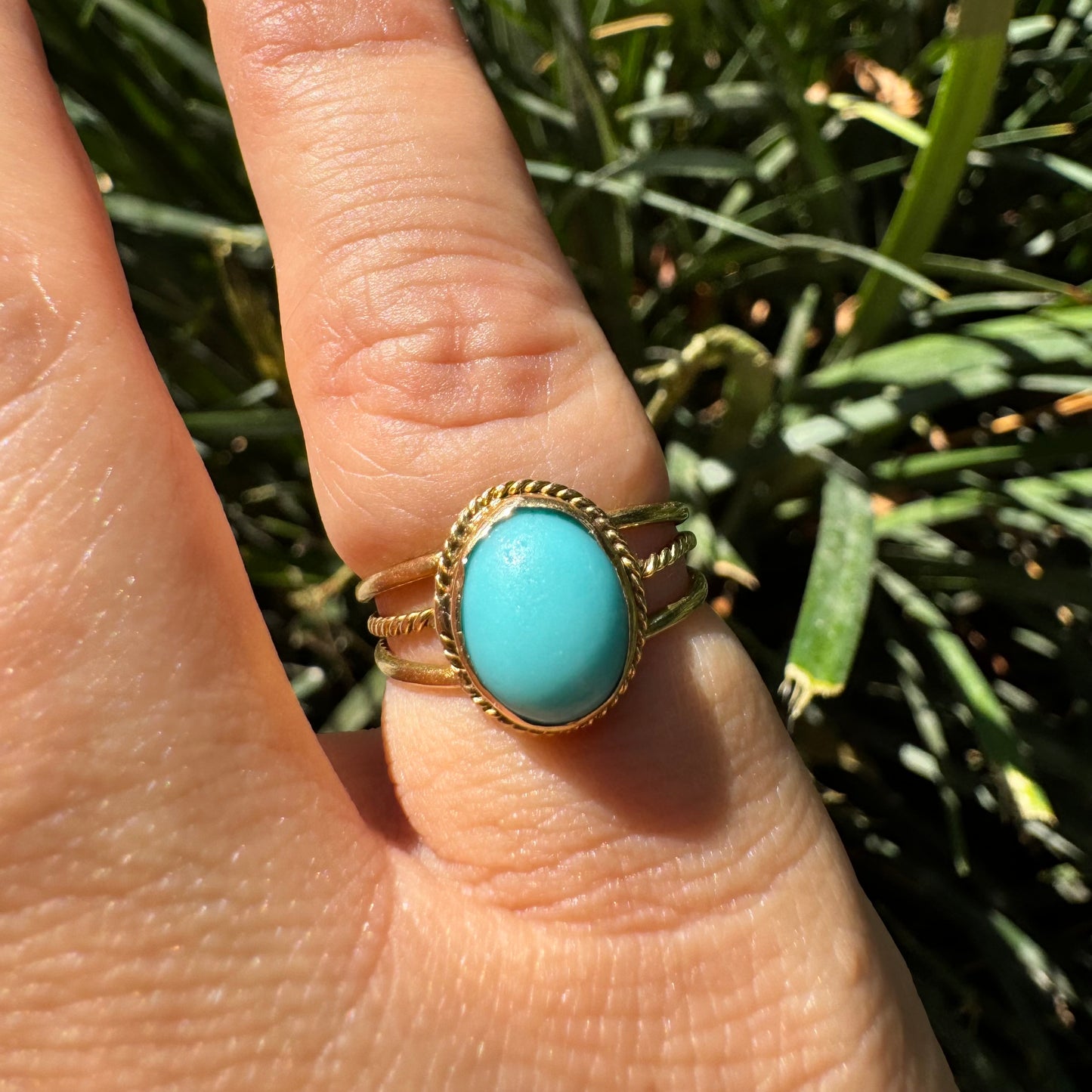 14K gold ring set with an oval Turquoise stone in a delicate rope-style bezel