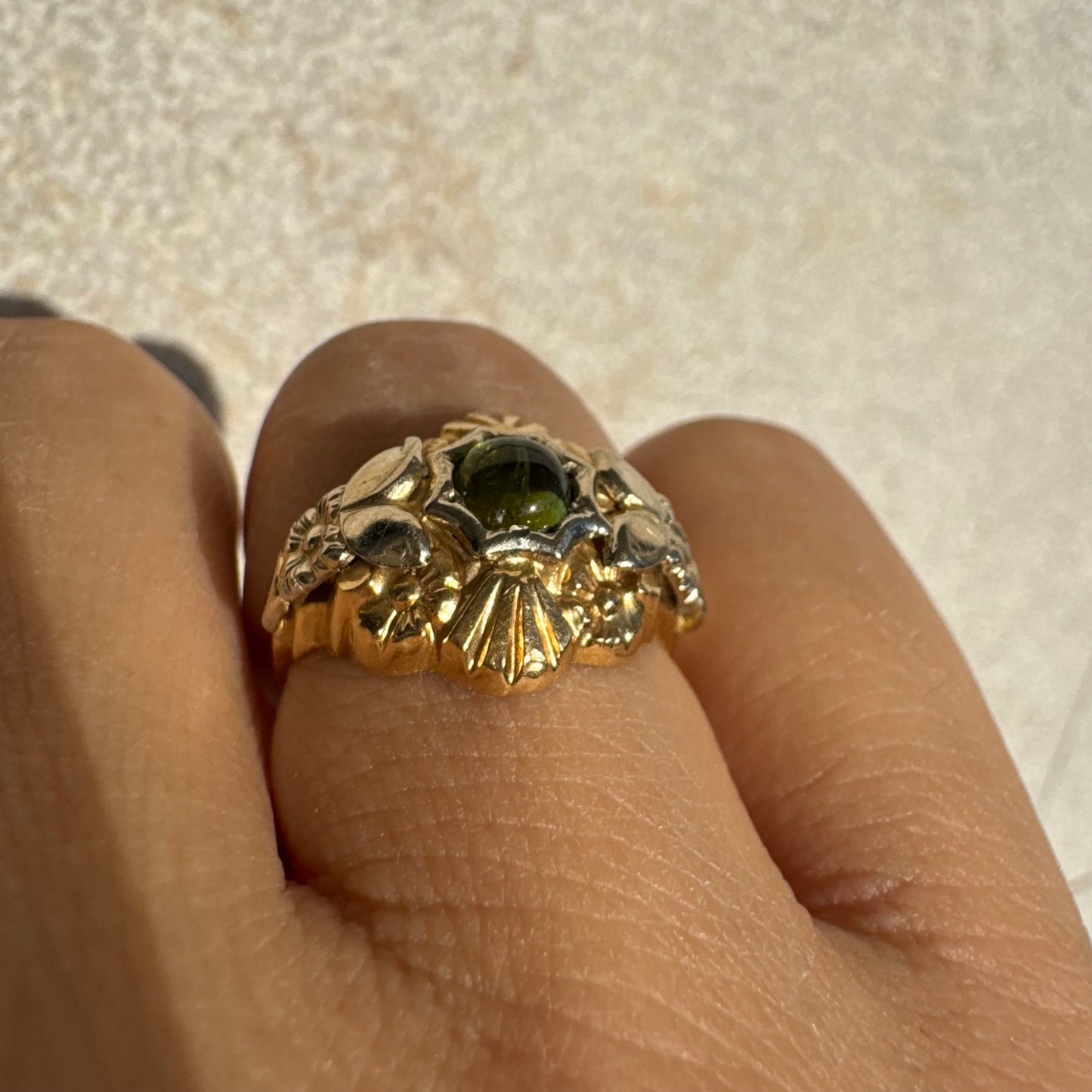 18K two-tone gold ring set with a deep green Tourmaline gemstone.