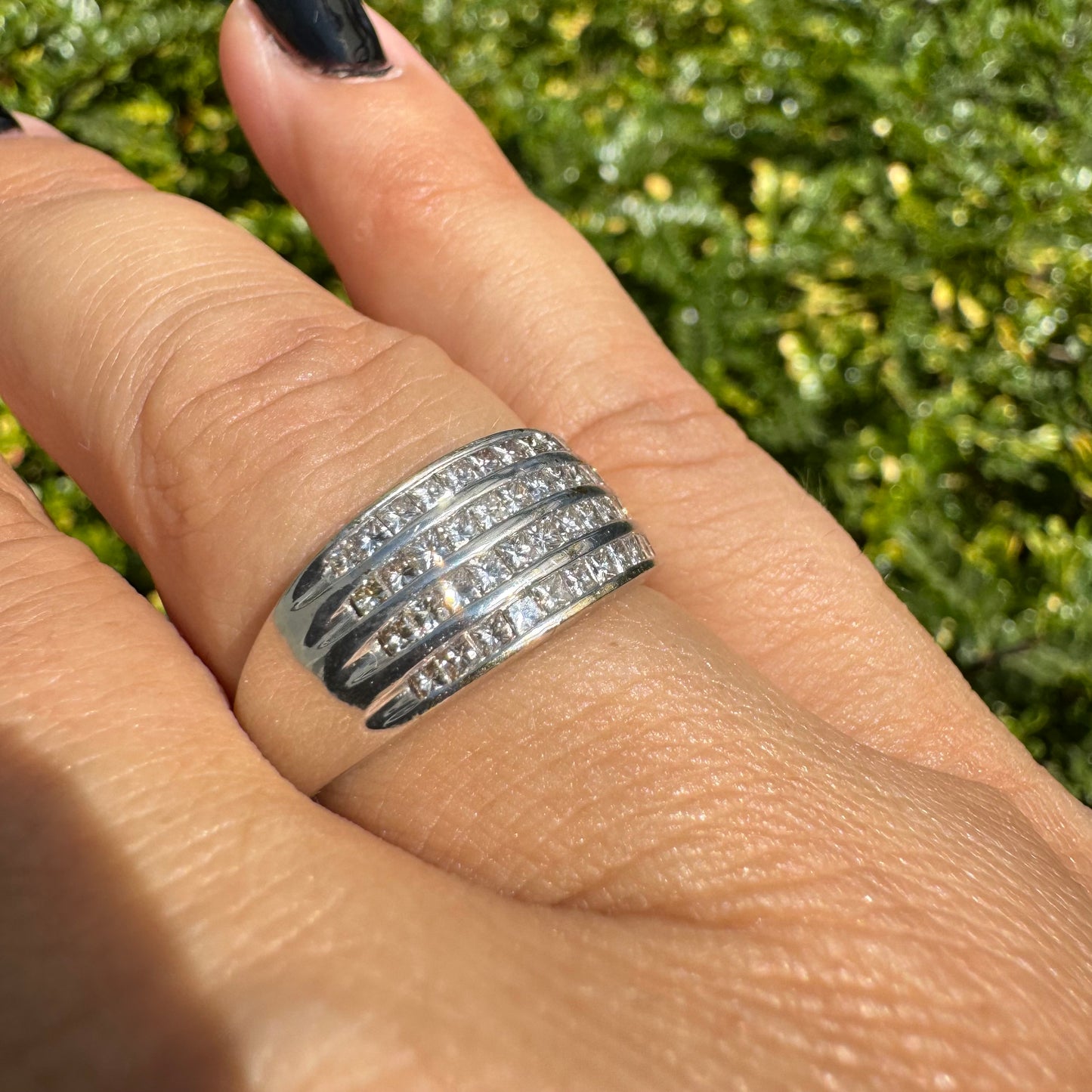 14K gold ring set with four parallel rows of princess-cut Diamonds.