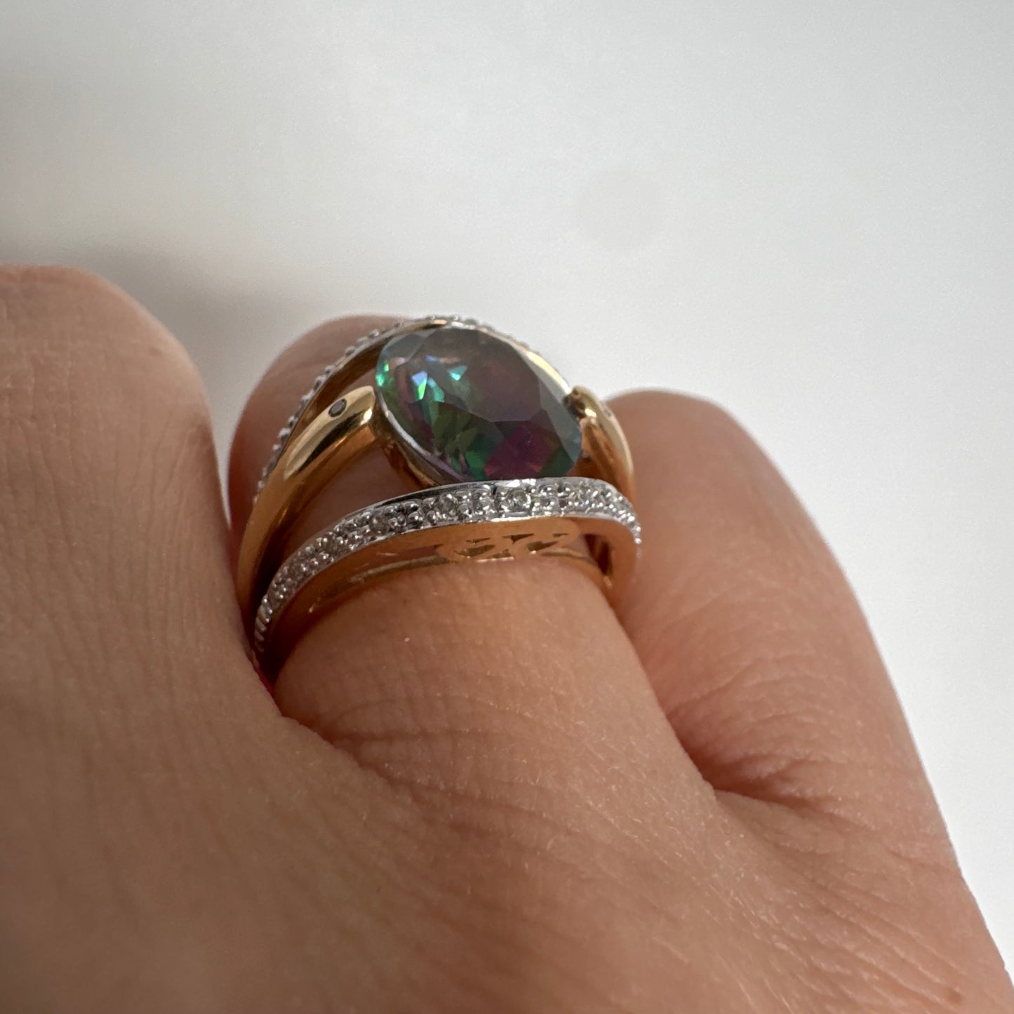 14K gold ring set with an oval Mystic Topaz