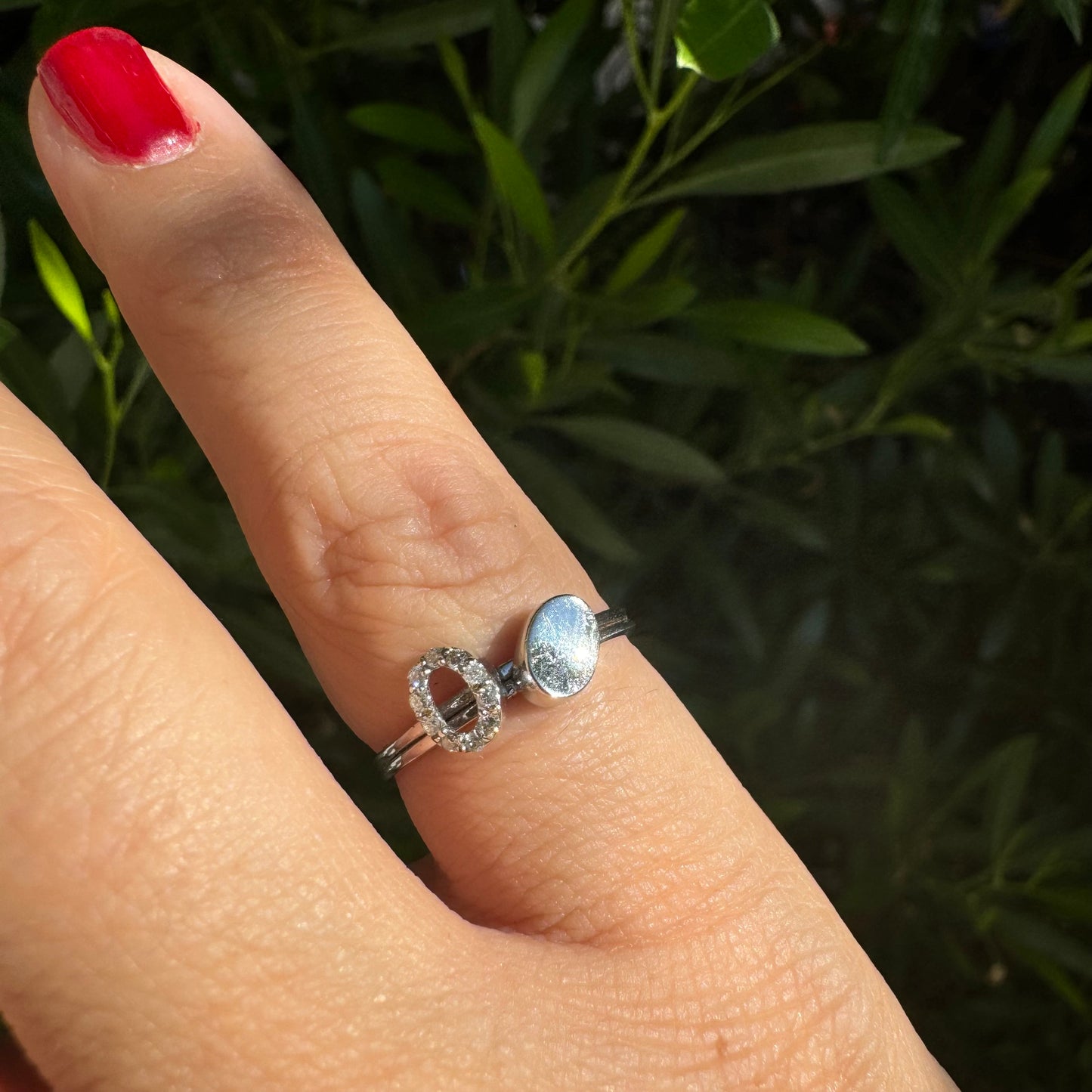 14K gold open ring featuring two ends: one with a sparkling oval of Diamonds and the other with a smooth polished oval.