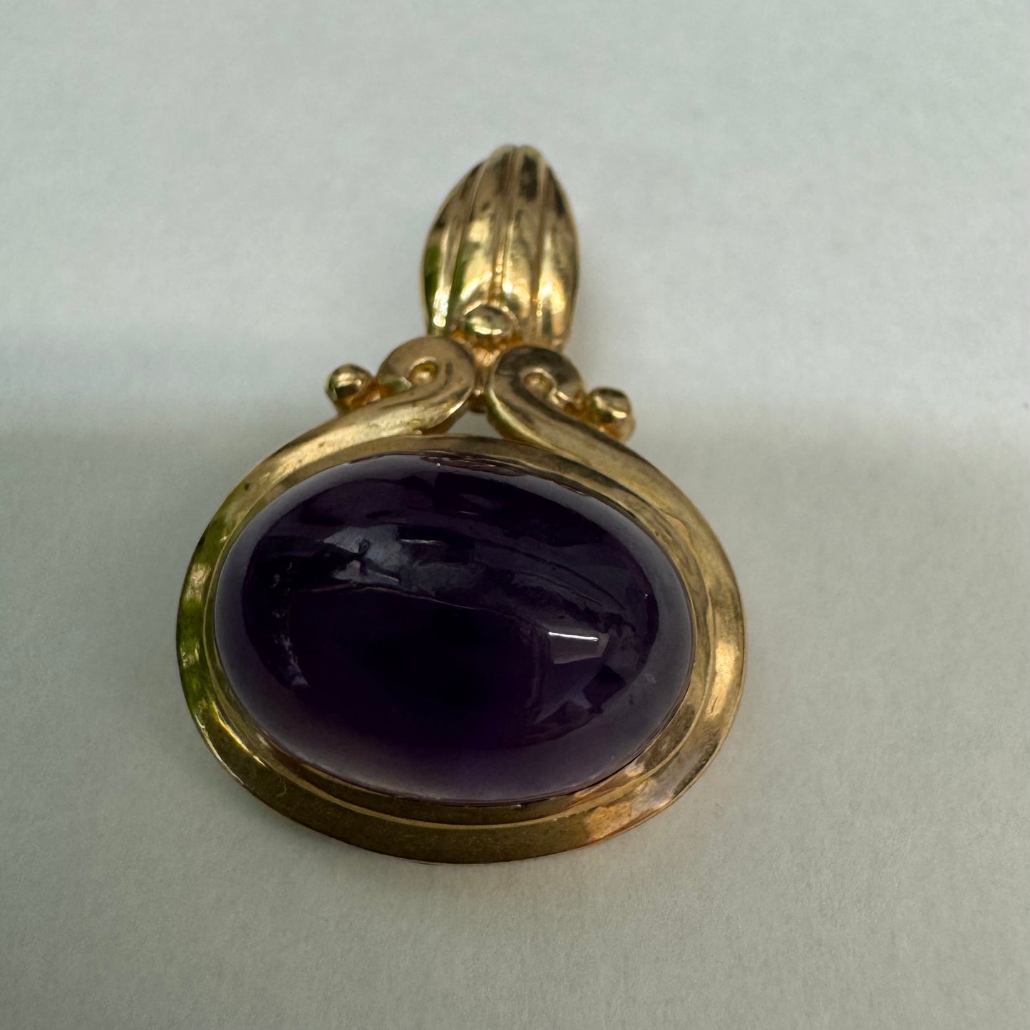 14K gold pendant set with a large cabochon Amethyst