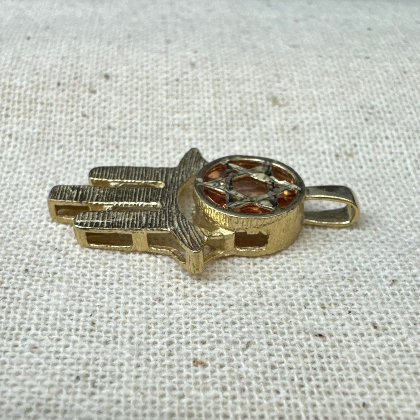 14K gold Hamsa pendant, featuring a deep orange gemstone framed by a Star of David.