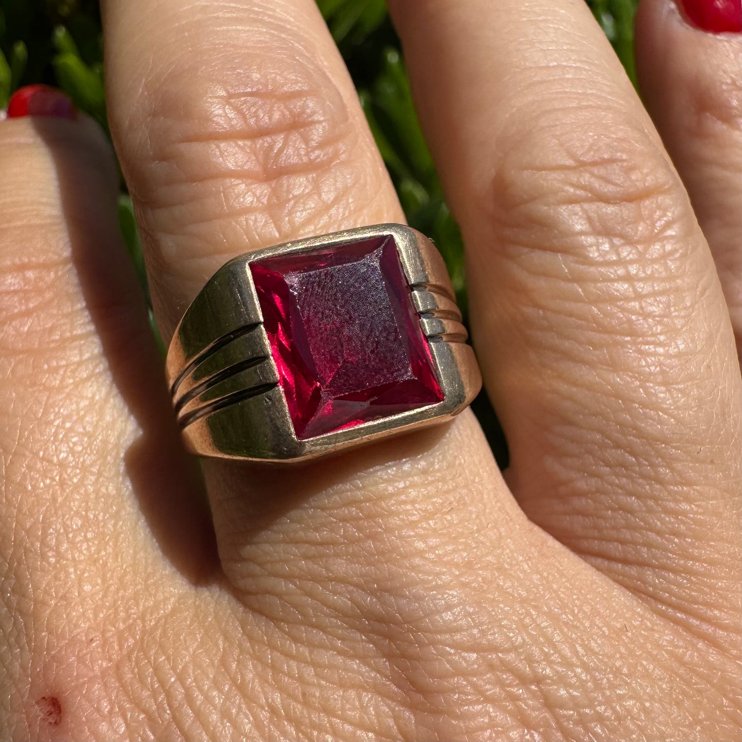 10K gold ring set with a bold red rectangular gemstone