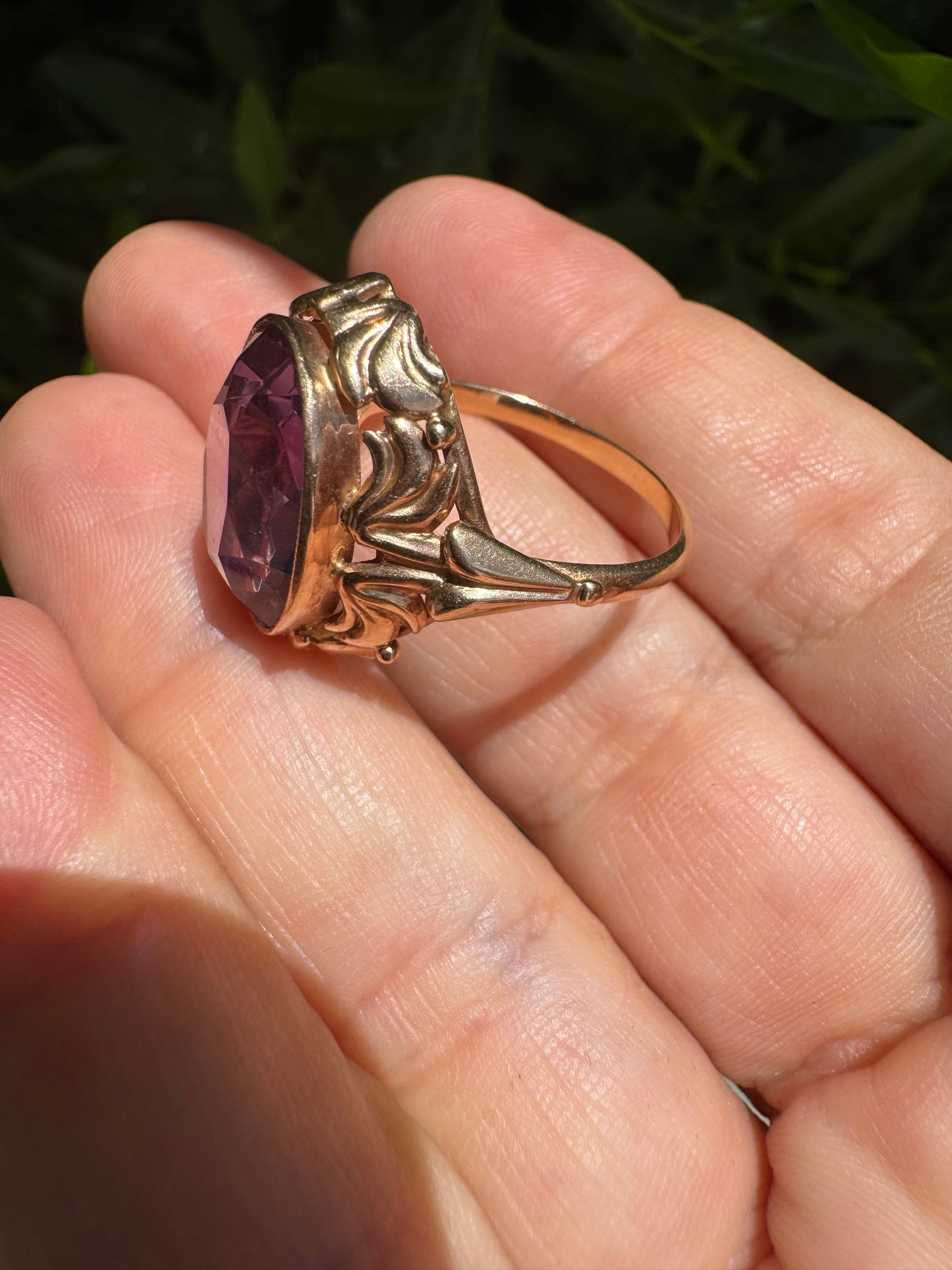 14K gold ring set with a large oval-cut Amethyst in a regal claw setting.