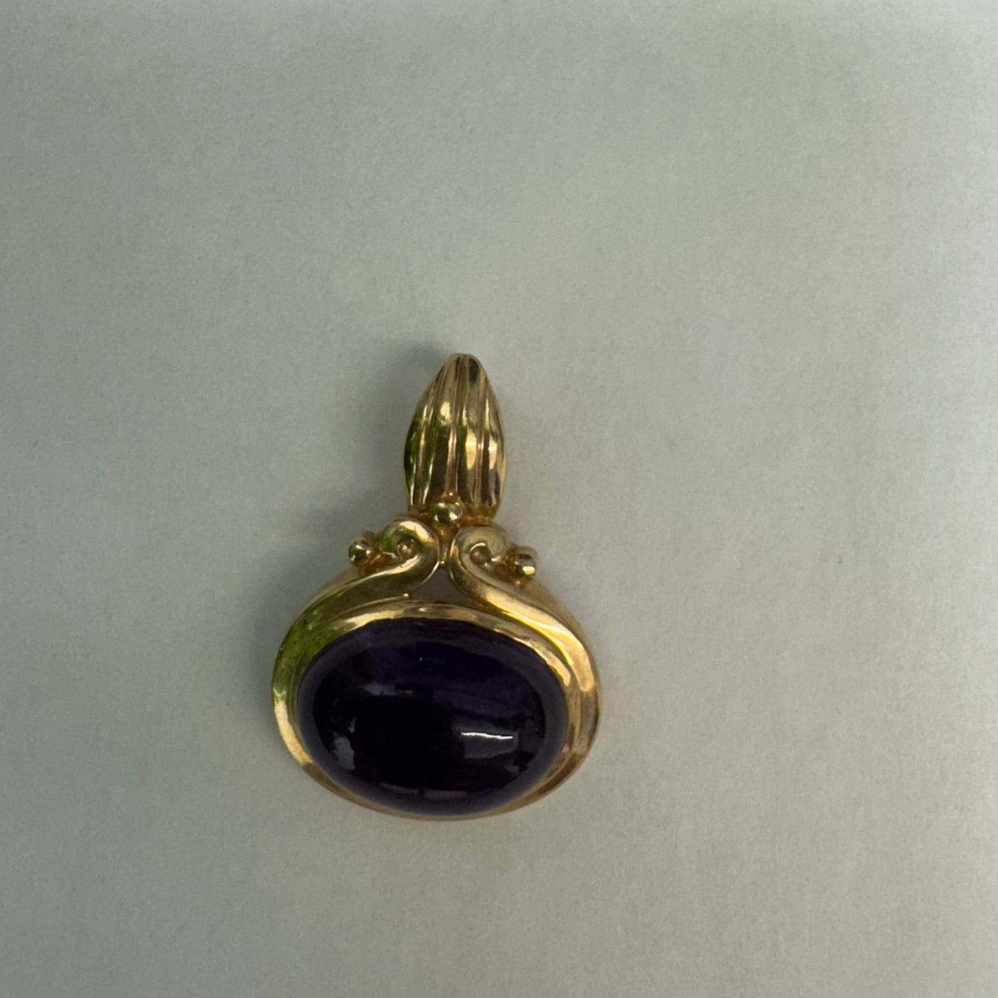 14K gold pendant set with a large cabochon Amethyst