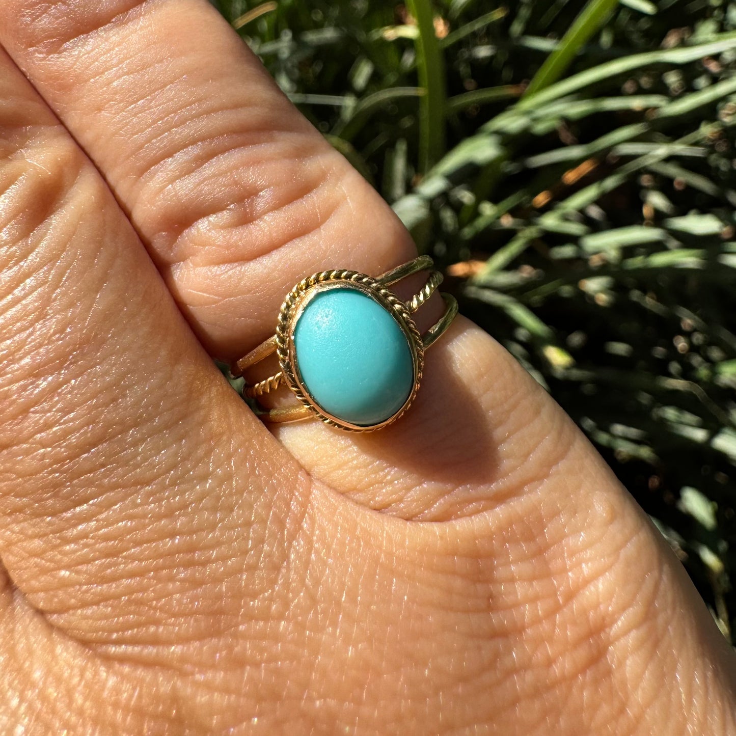 14K gold ring set with an oval Turquoise stone in a delicate rope-style bezel