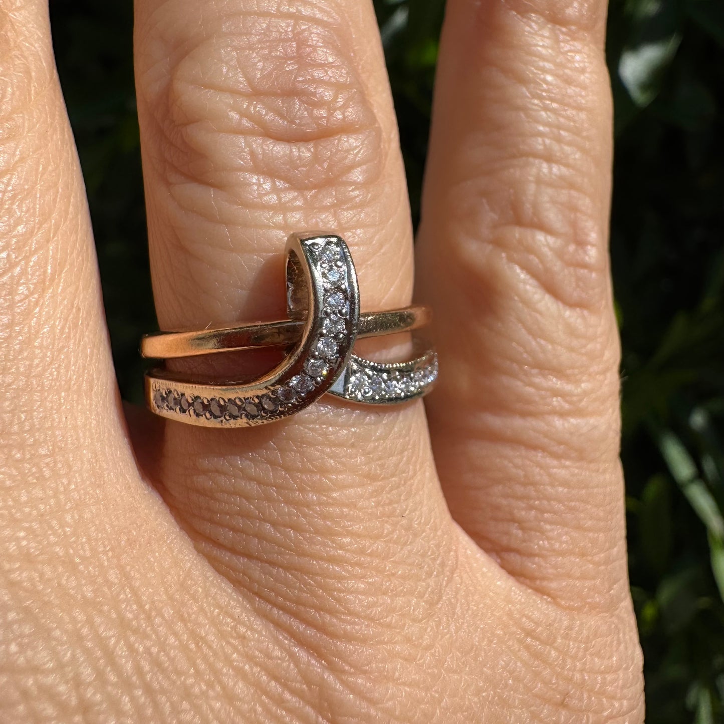 18K two-tone gold (rose & white) crossover ring featuring a row of sparkling Diamonds along each band, creating an elegant and modern design.