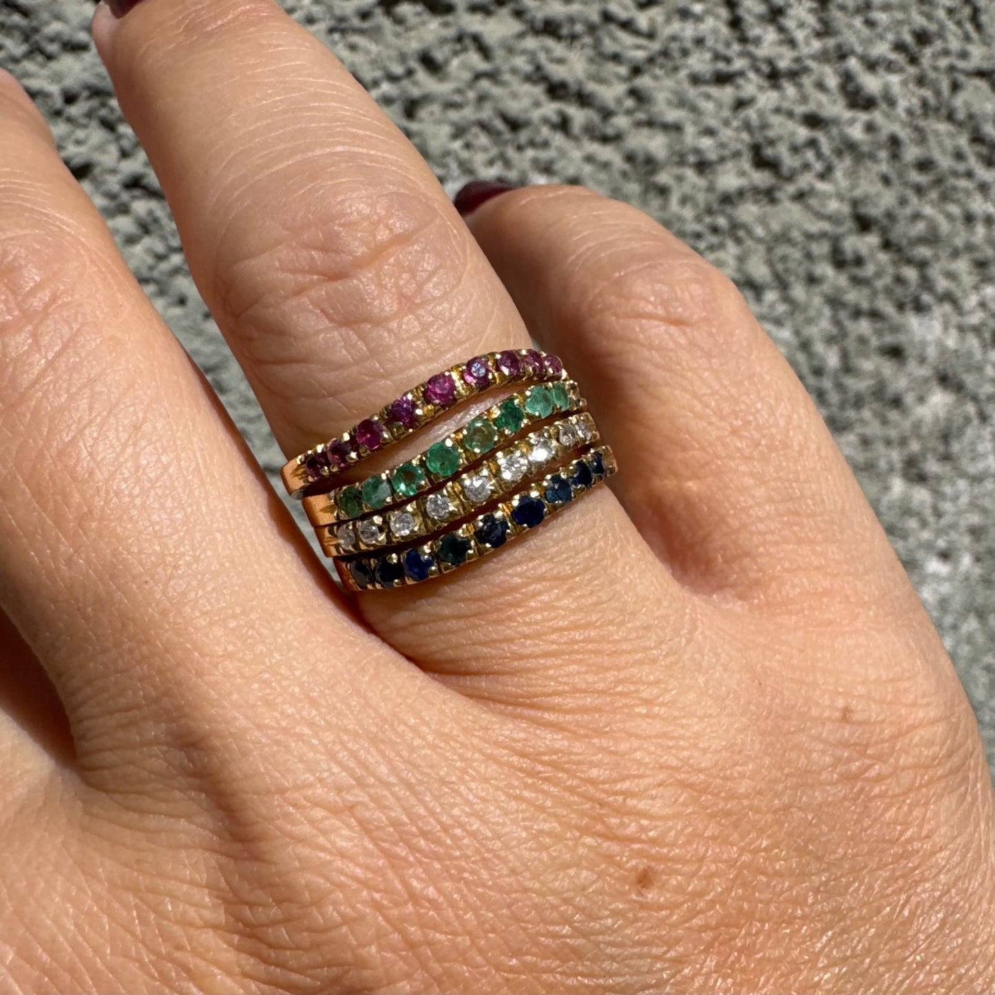 18K yellow gold ring set with vibrant rows of Sapphires, Emeralds, Rubies, and Diamonds