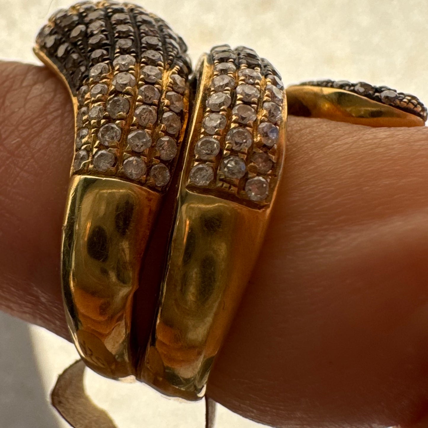 14K gold snake ring fully set with white and black Diamonds, creating a striking contrast and luxurious sparkle.